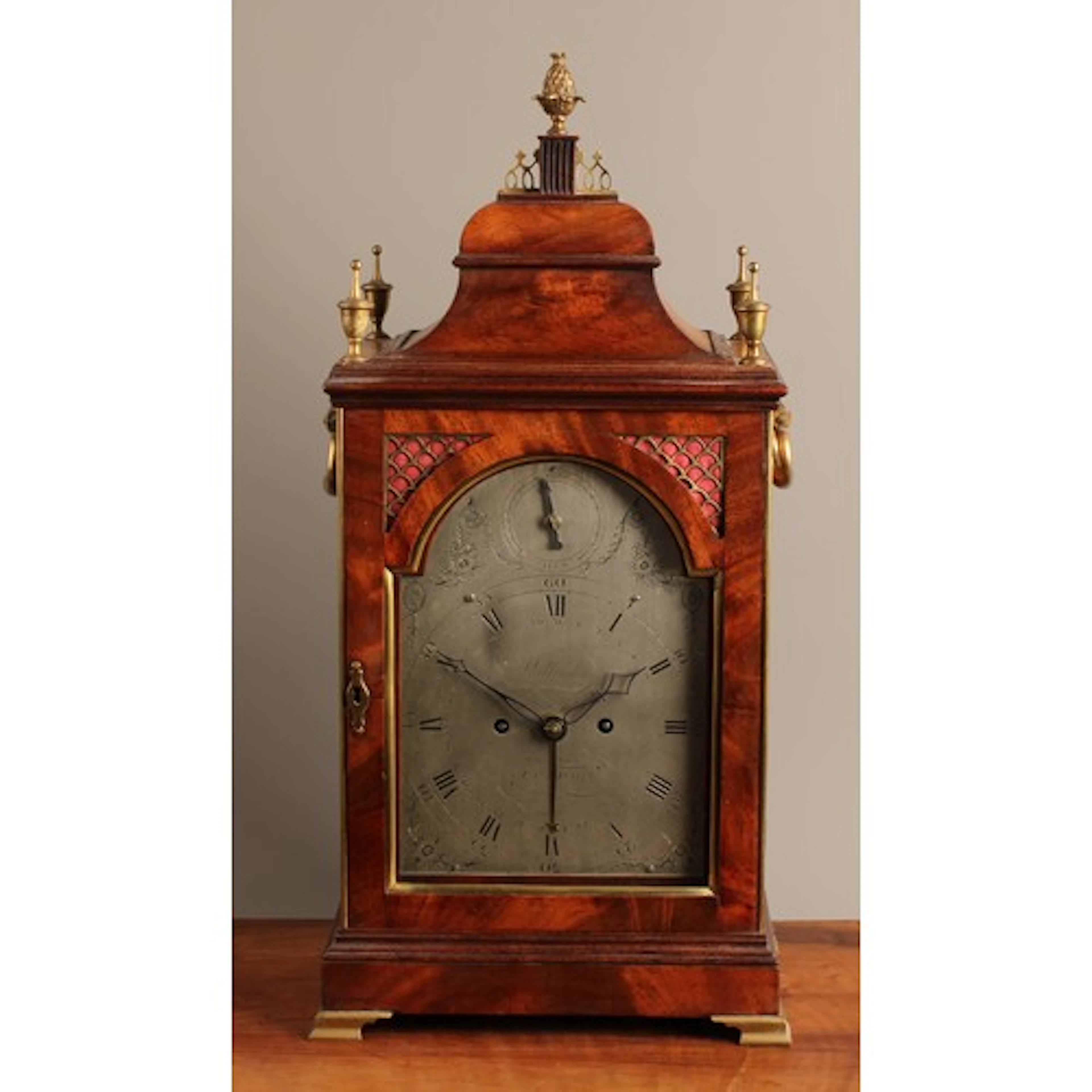 A George III mahogany veneered and brass mounted 8-day twin ...