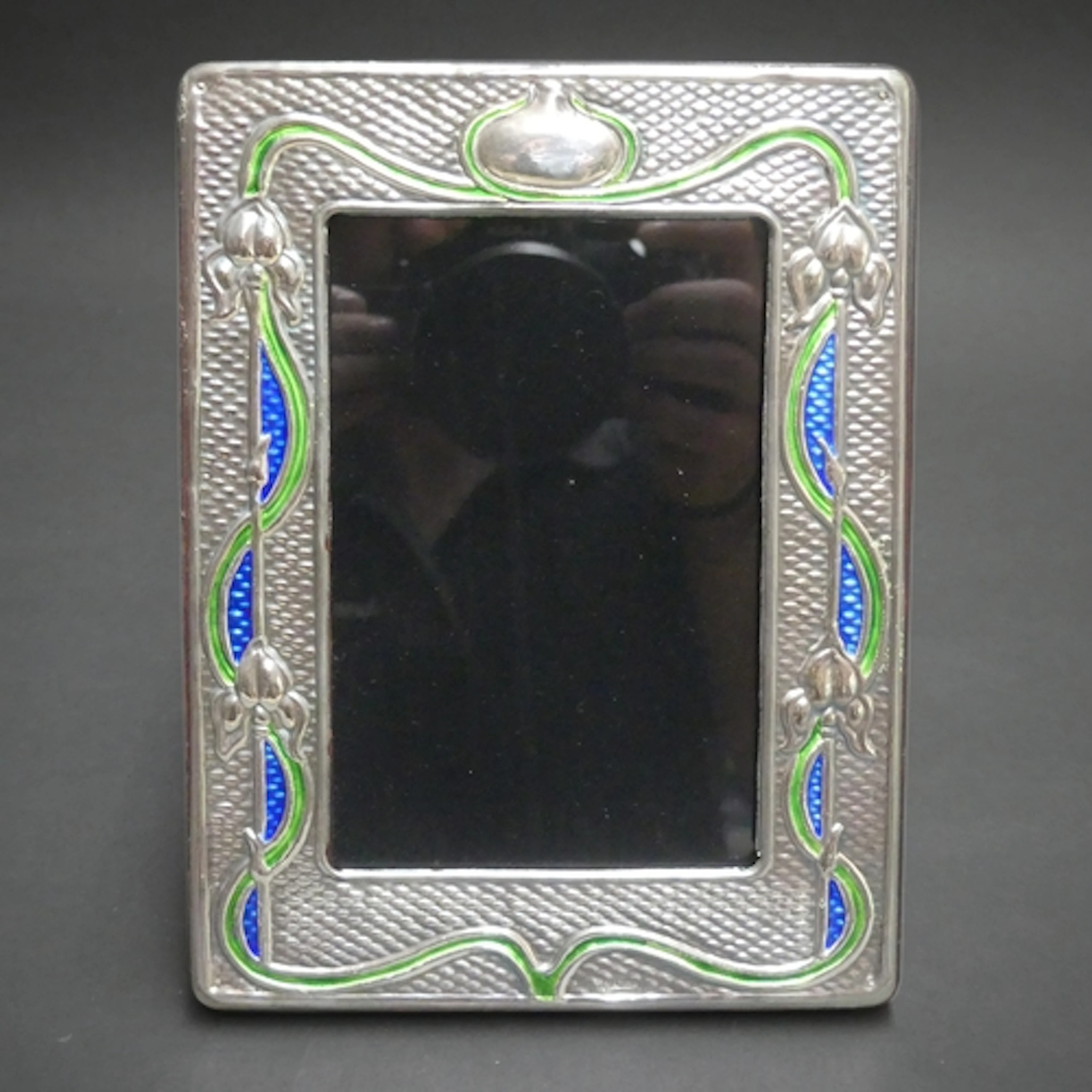 An Art Nouveau design silver and enamel fronted photo frame,...
