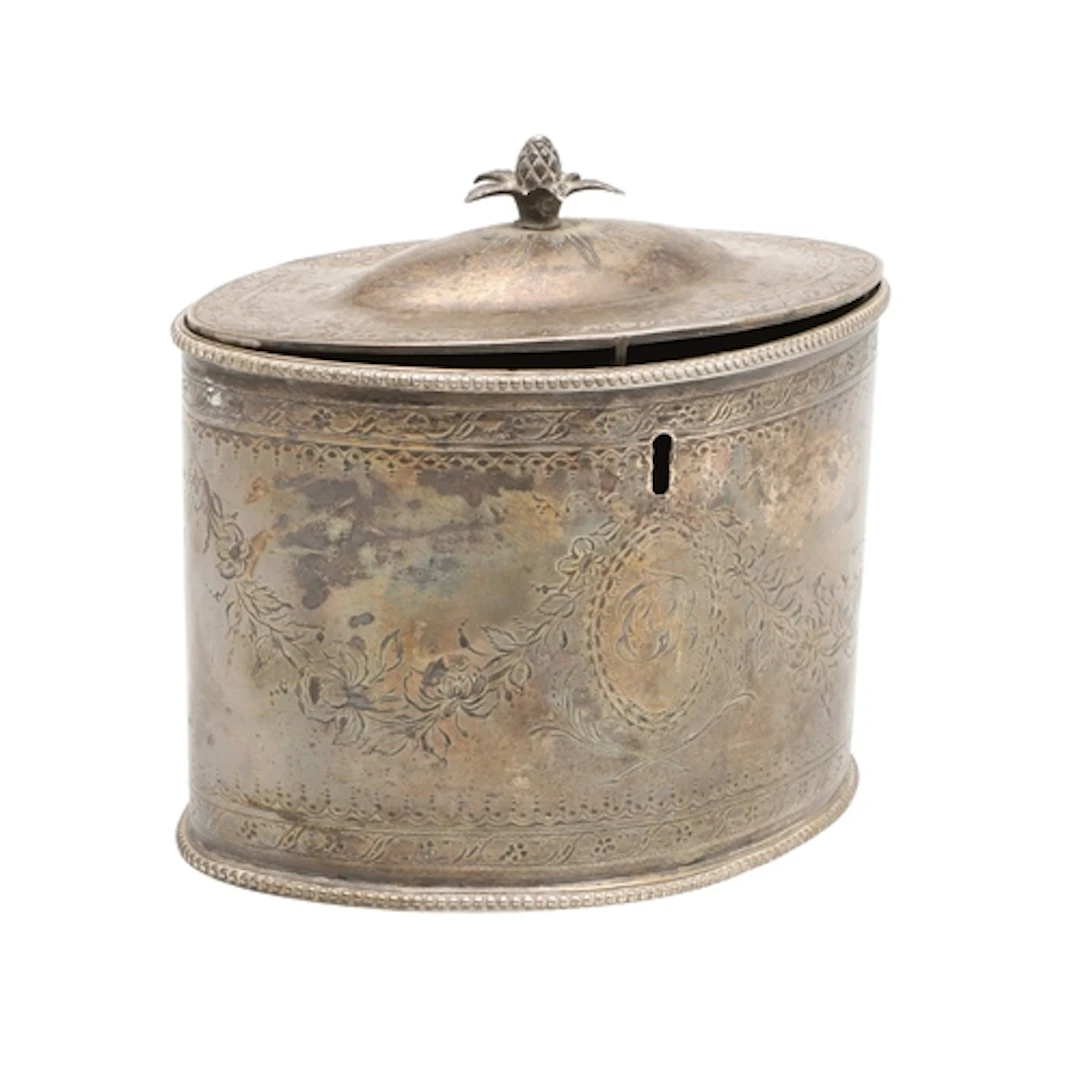 A GEORGE III TEA CADDY. oval with domed cover and pineapple ...