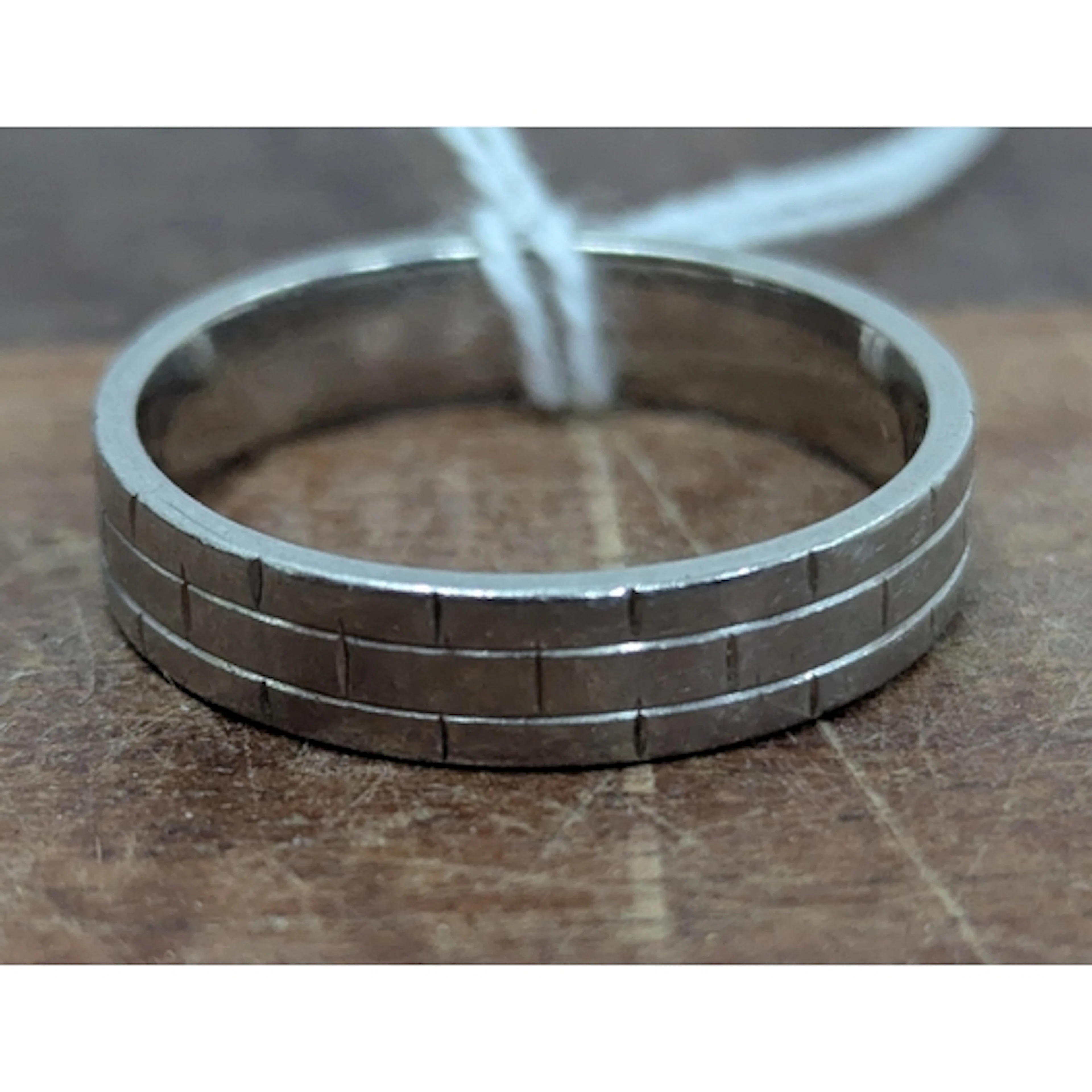 A palladium ring with a staggered brick design, size W Locat...