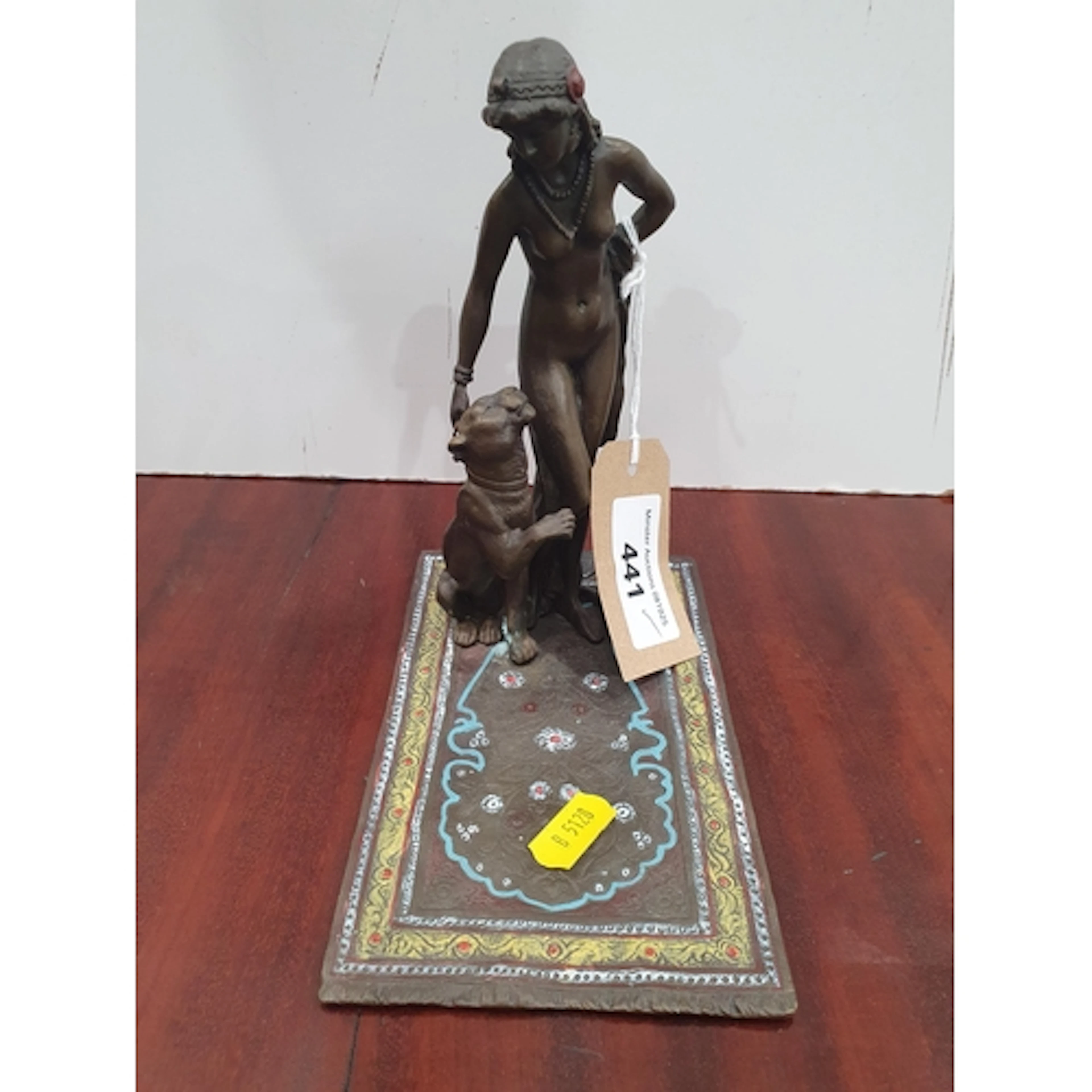 A cast metal Figure of a female nude with a panther standing...