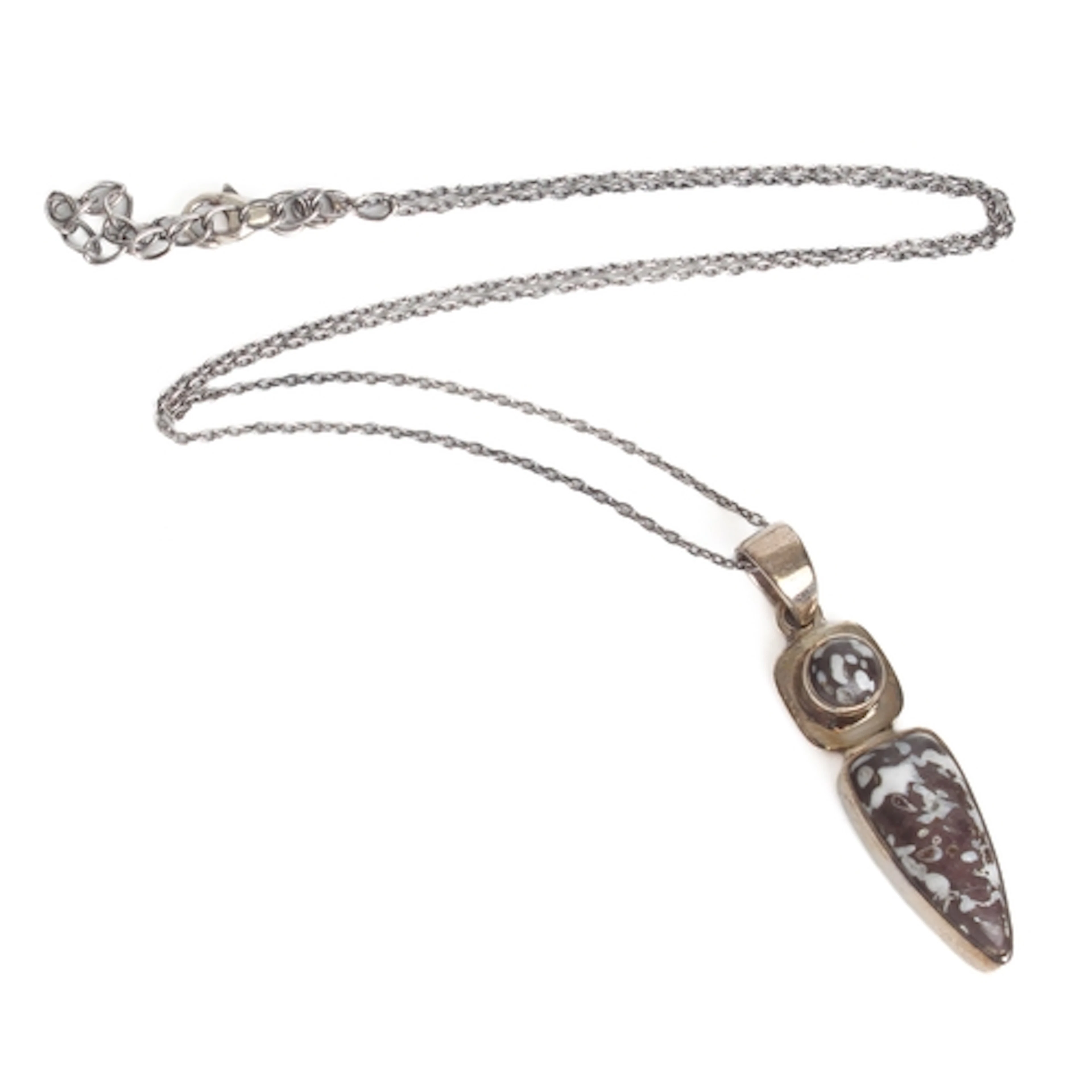 A sterling silver and fossilised dinosaur bone pendant - 43m...