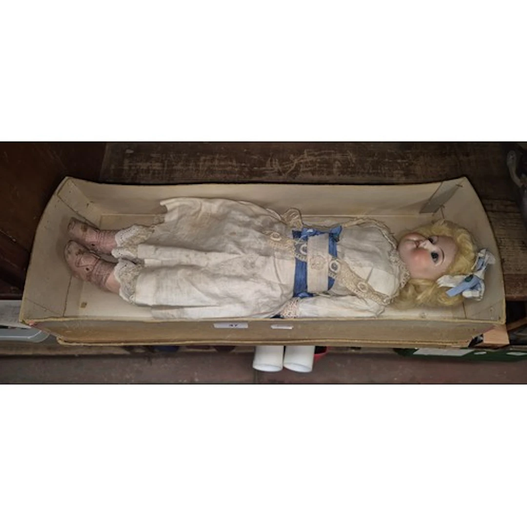 An Armand Marseille 370 bisque headed doll with leather body...