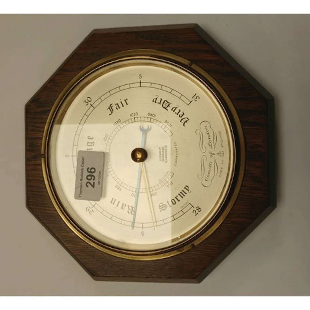 Comitti of London oak cased octagonal barometer.