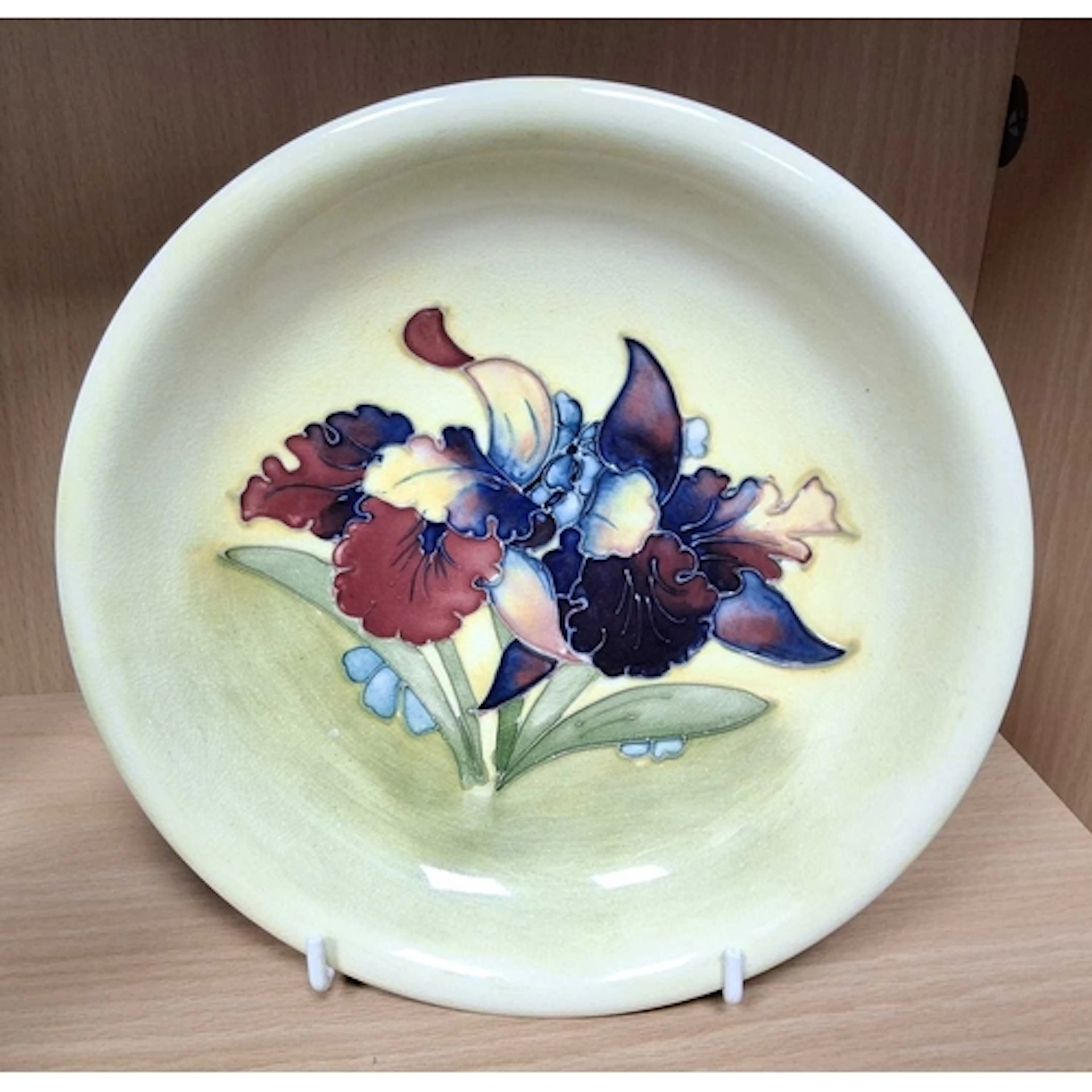 A MOORCROFT POTTERY ORCHID PATTERN BOWL, tube-lined with red...