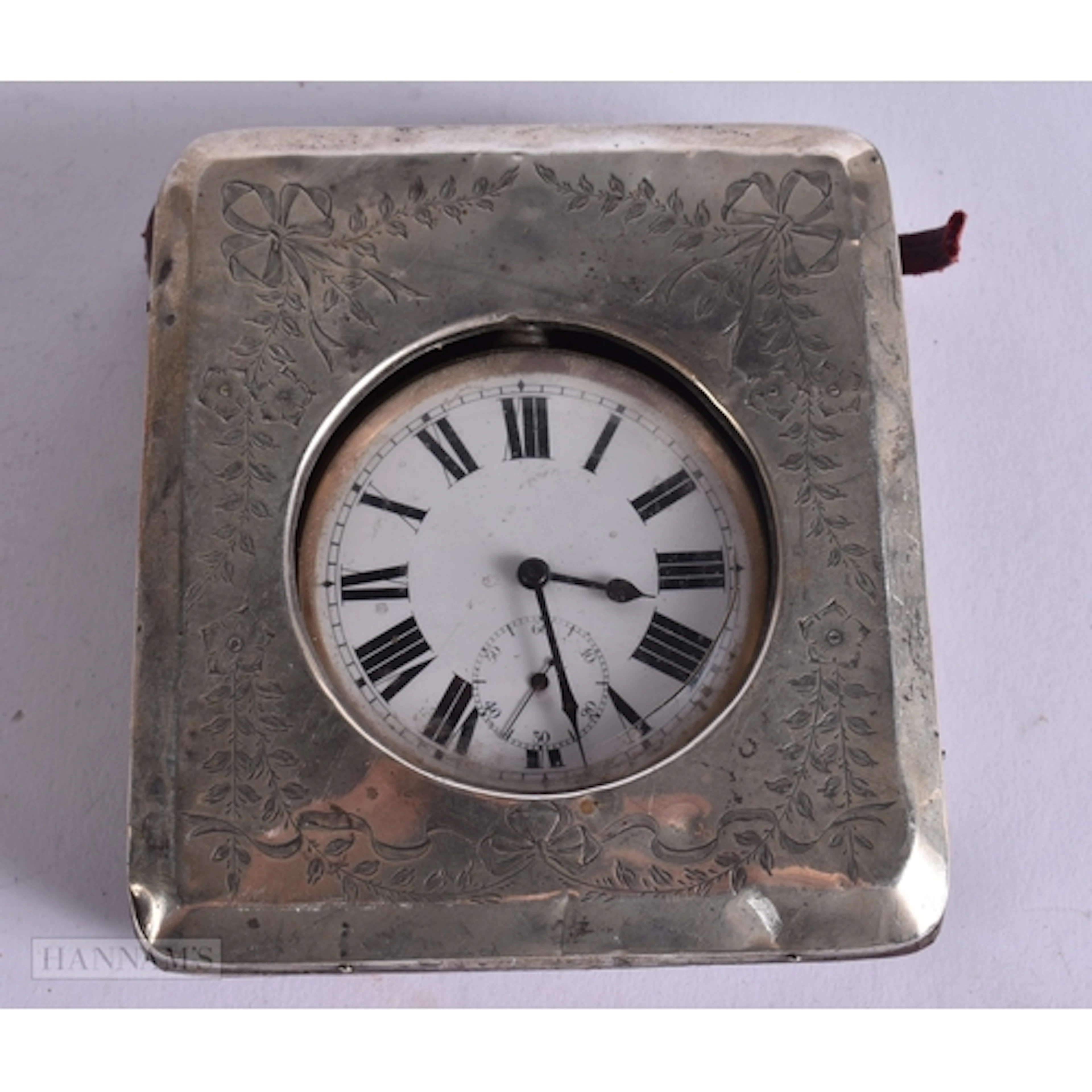 AN ANTIQUE SILVER CASED TRAVELLING CLOCK. Running. 10 cm x 1...