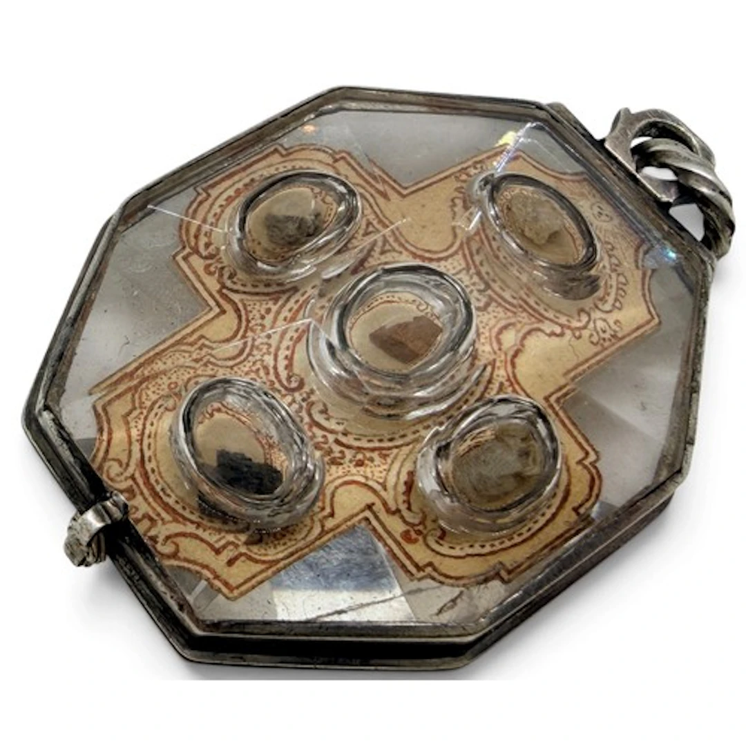 A rock-crystal reliquary pendant mounted in white metal with...