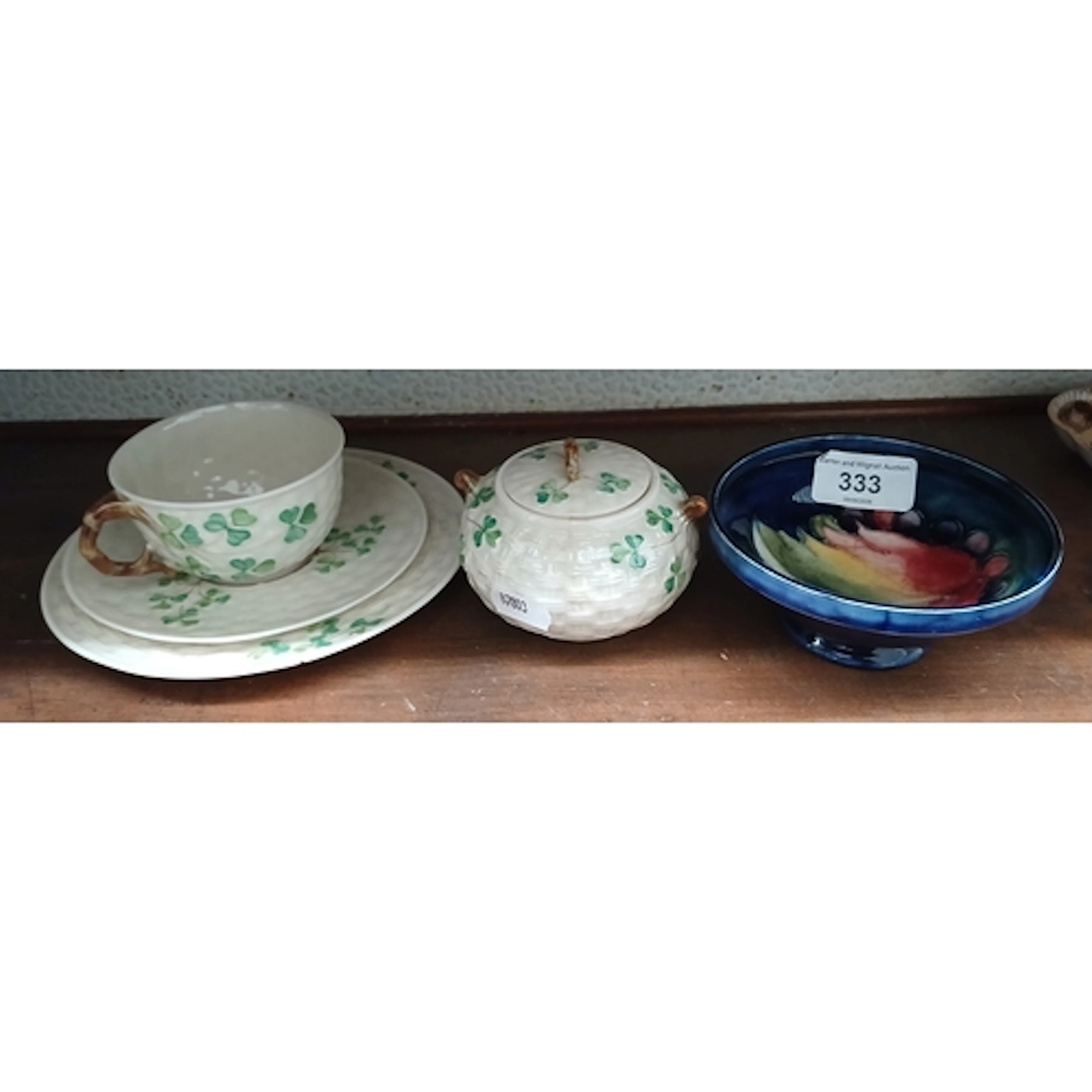 A Belleek cup saucer and side plate and a lidded pot, togeth...