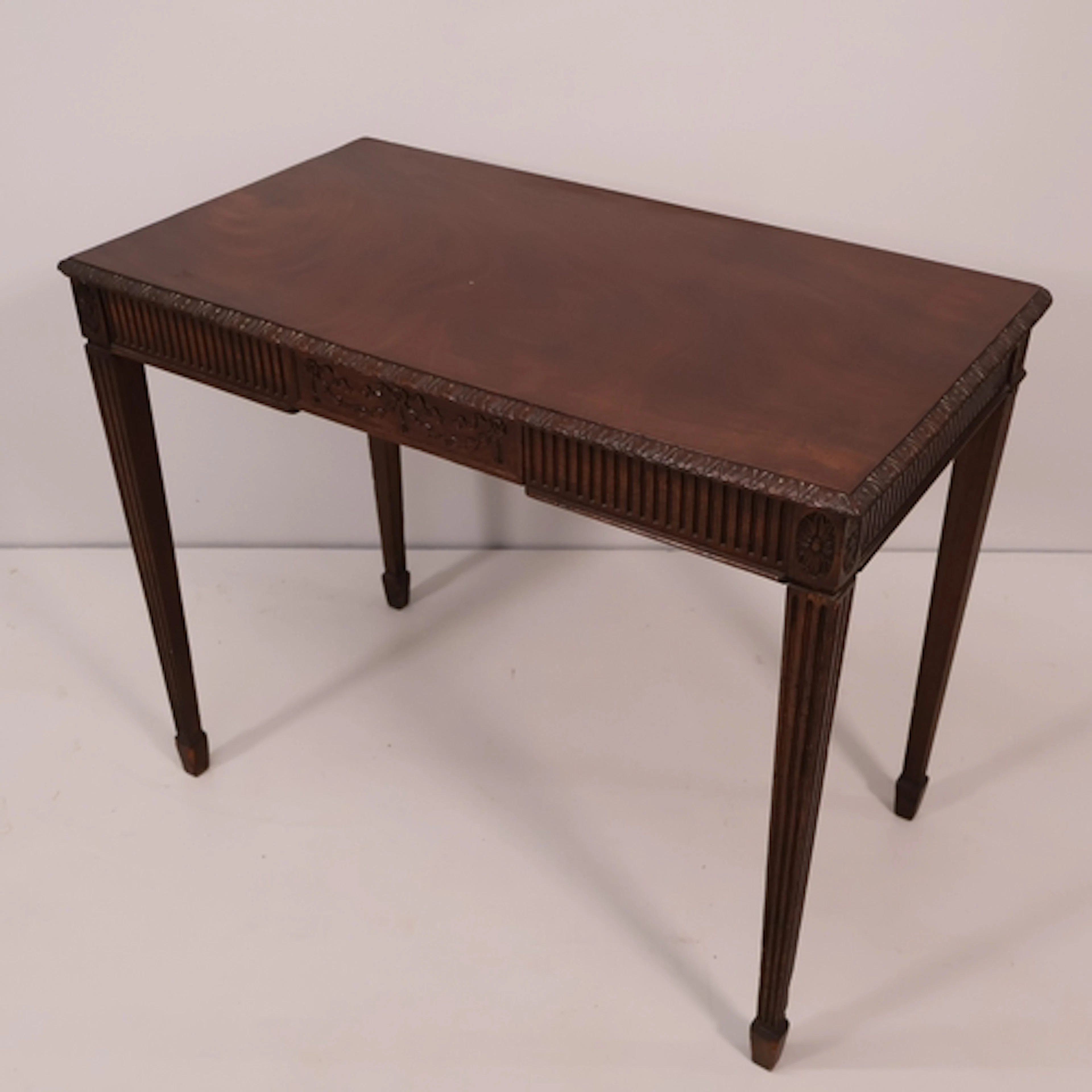 A Chippendale style mahogany writing table, with single carv...