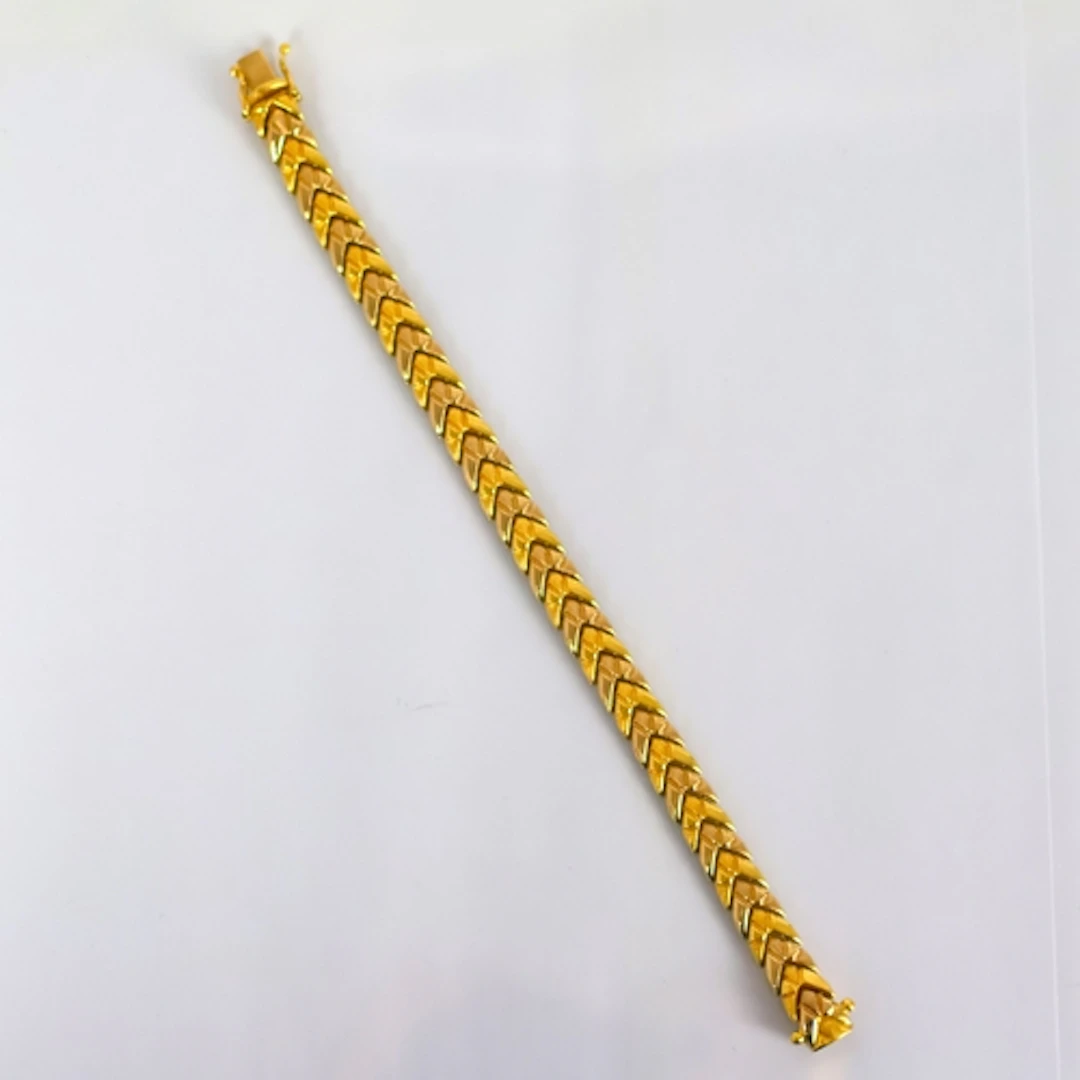 A yellow metal bracelet, possibly Italian, the chevron shape...