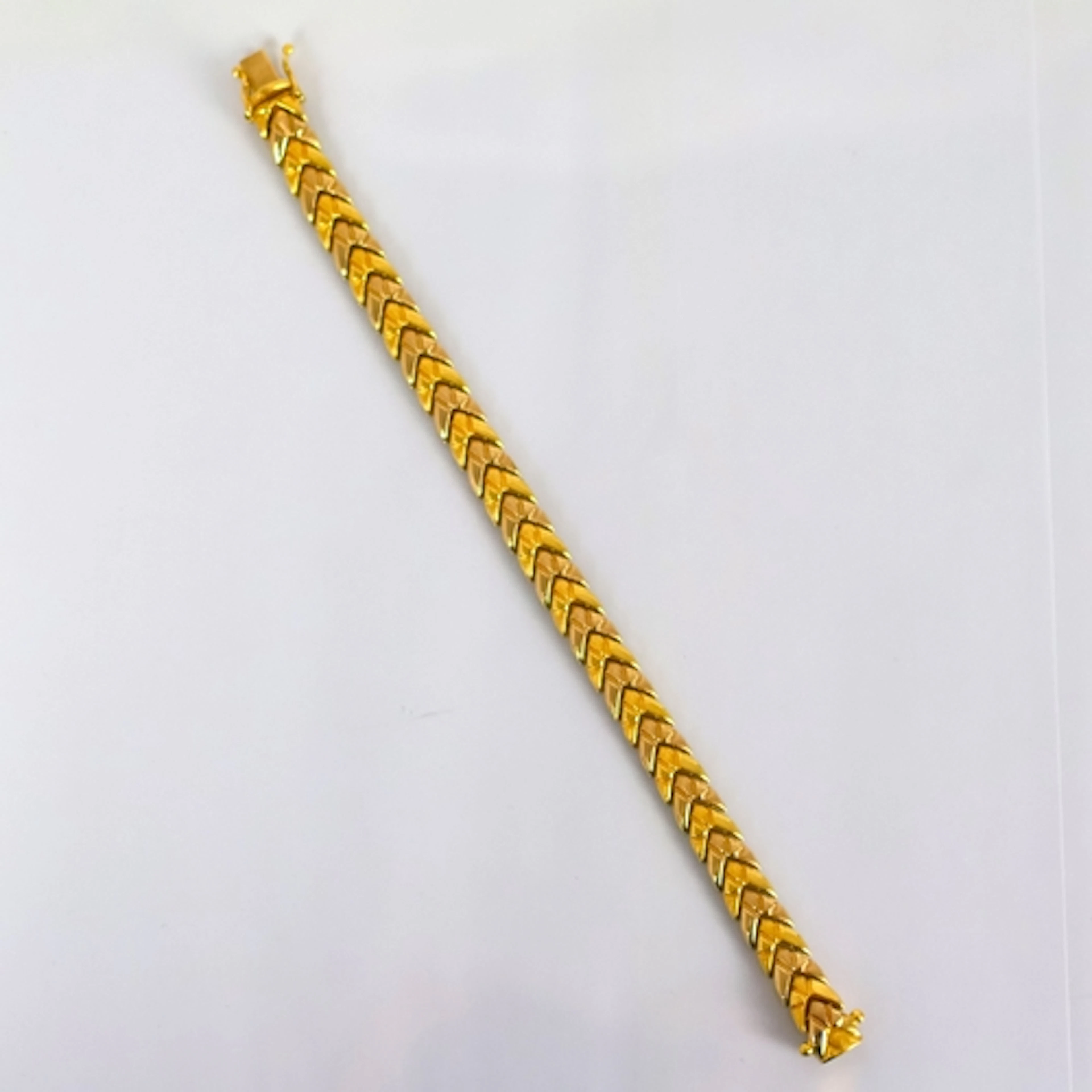 A yellow metal bracelet, possibly Italian, the chevron shape...