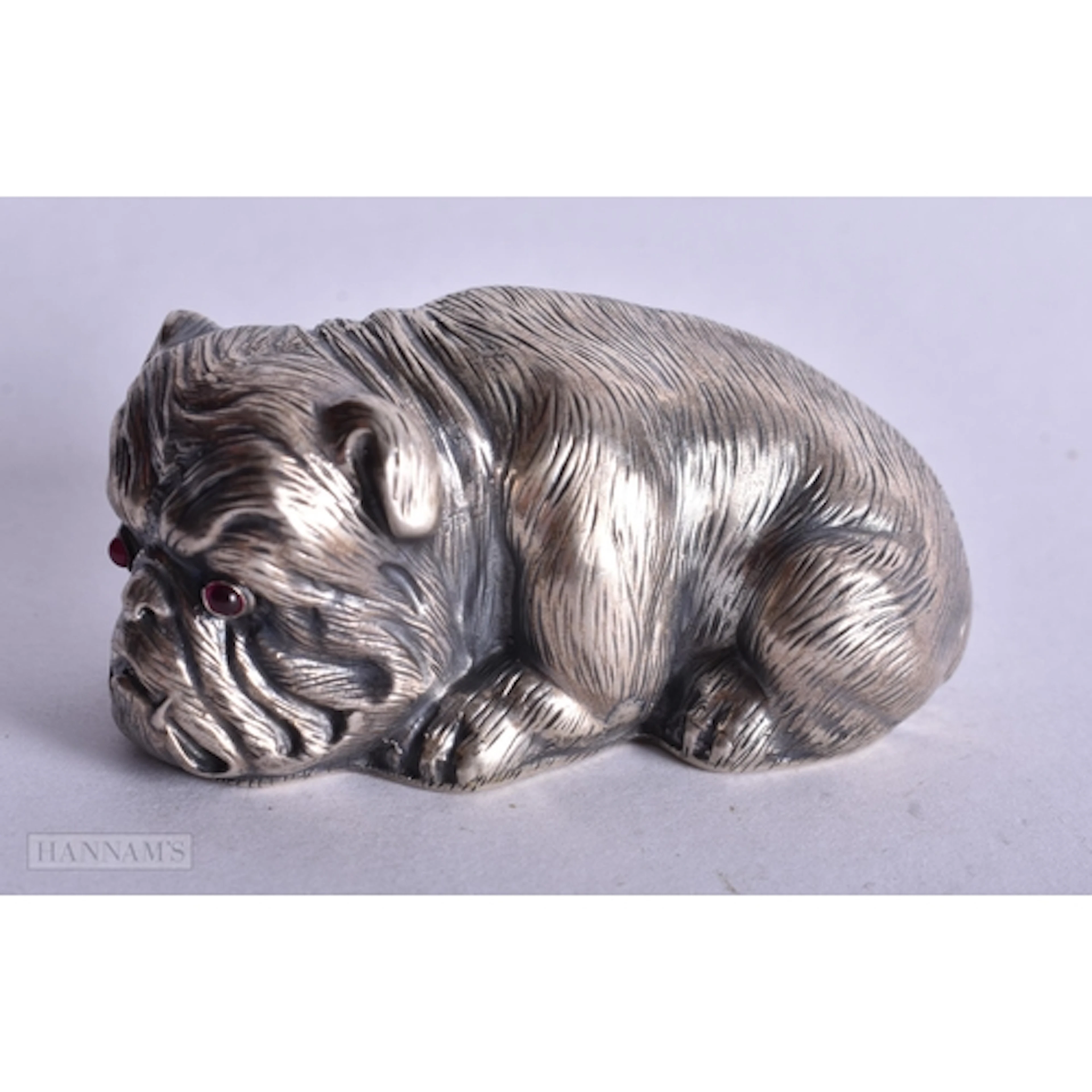 A CONTINENTAL SILVER AND RUBY EYED DOG. 58.8 grams. 6.5 cm x...