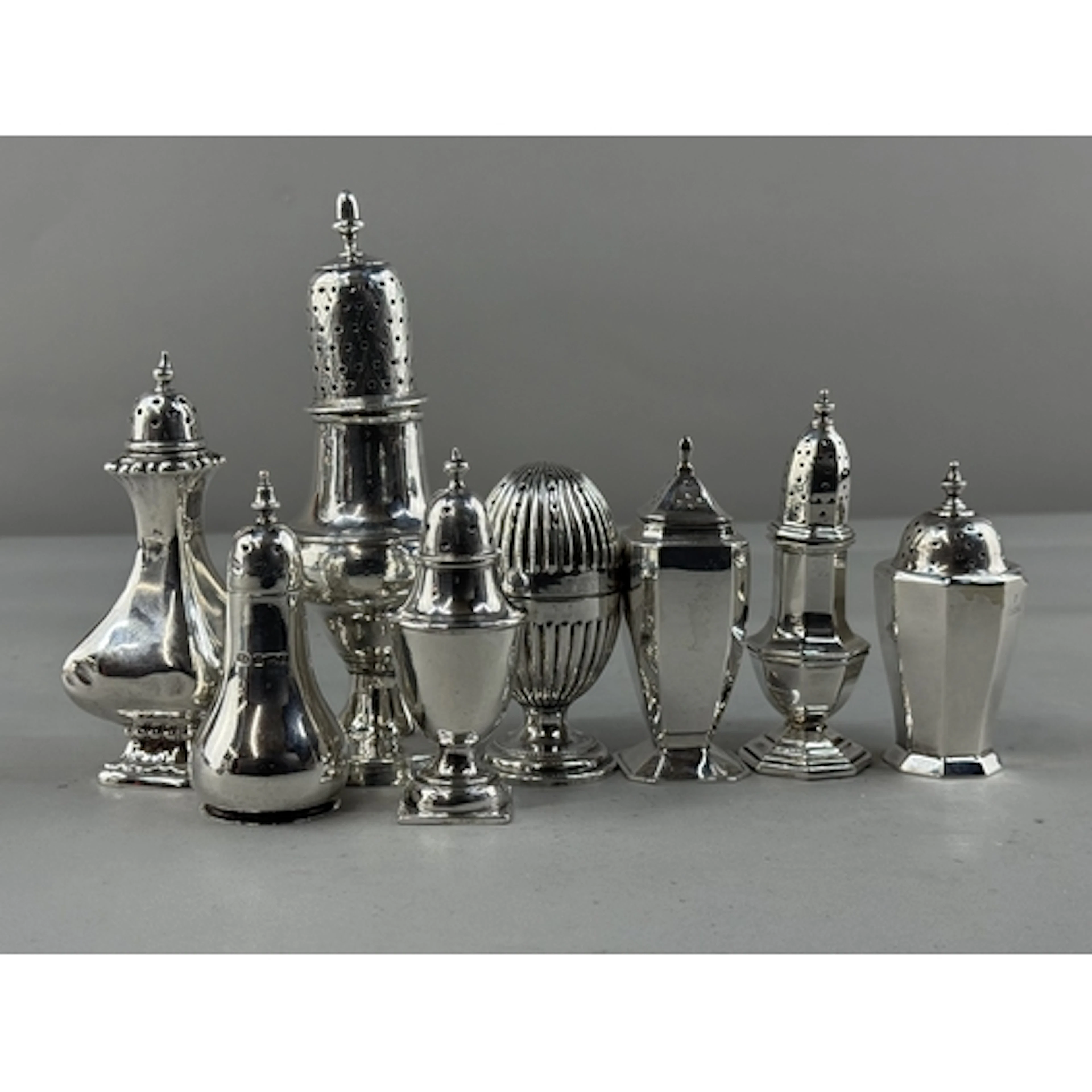 Silver: a group of seven pepperettes of various designs, mak...