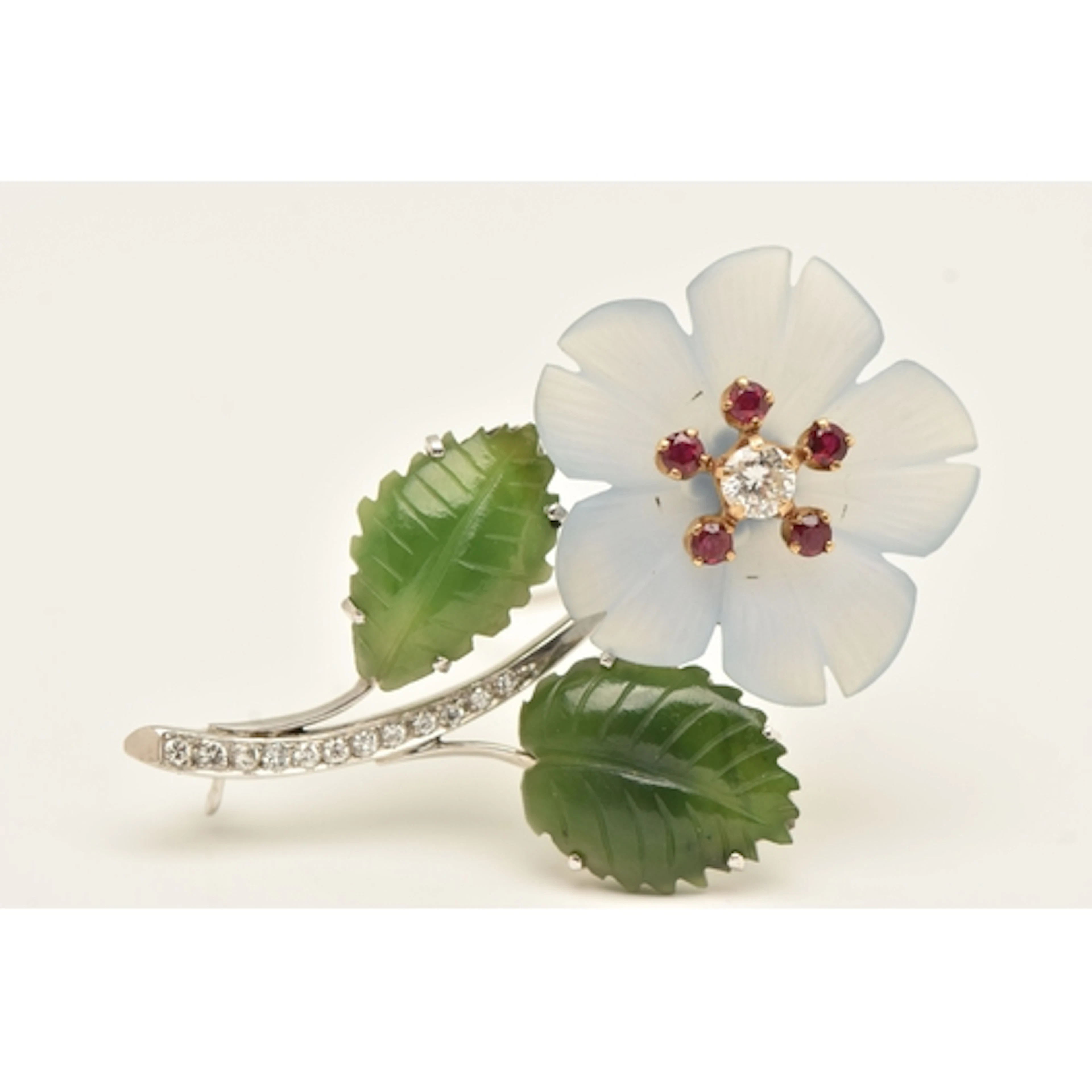 A MID 20TH CENTURY FLORAL BROOCH, comprised of a carved chal...