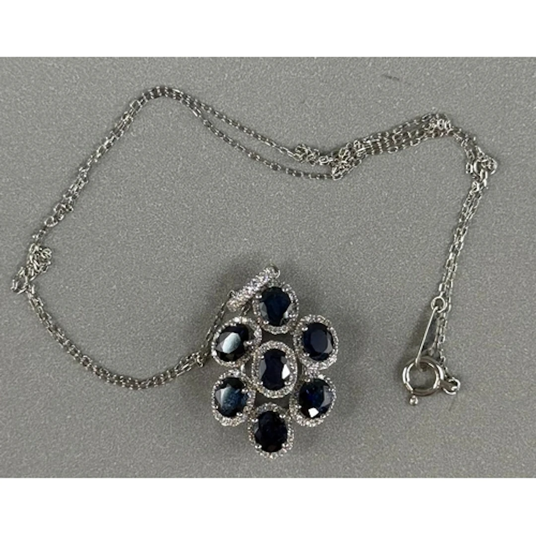 Jewellery: White metal, 36cm chain with an oval pendant atta...