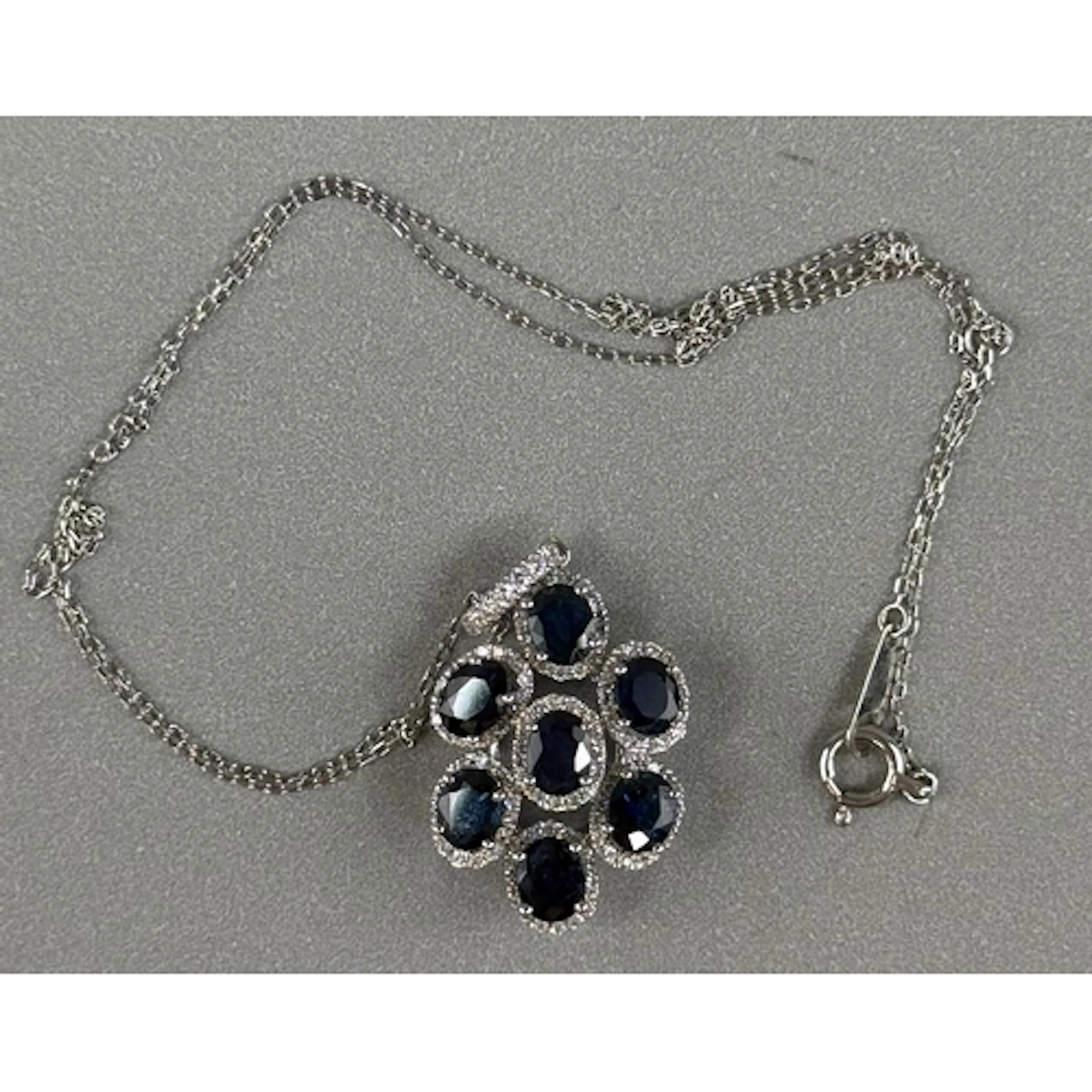 Jewellery: White metal, 36cm chain with an oval pendant atta...