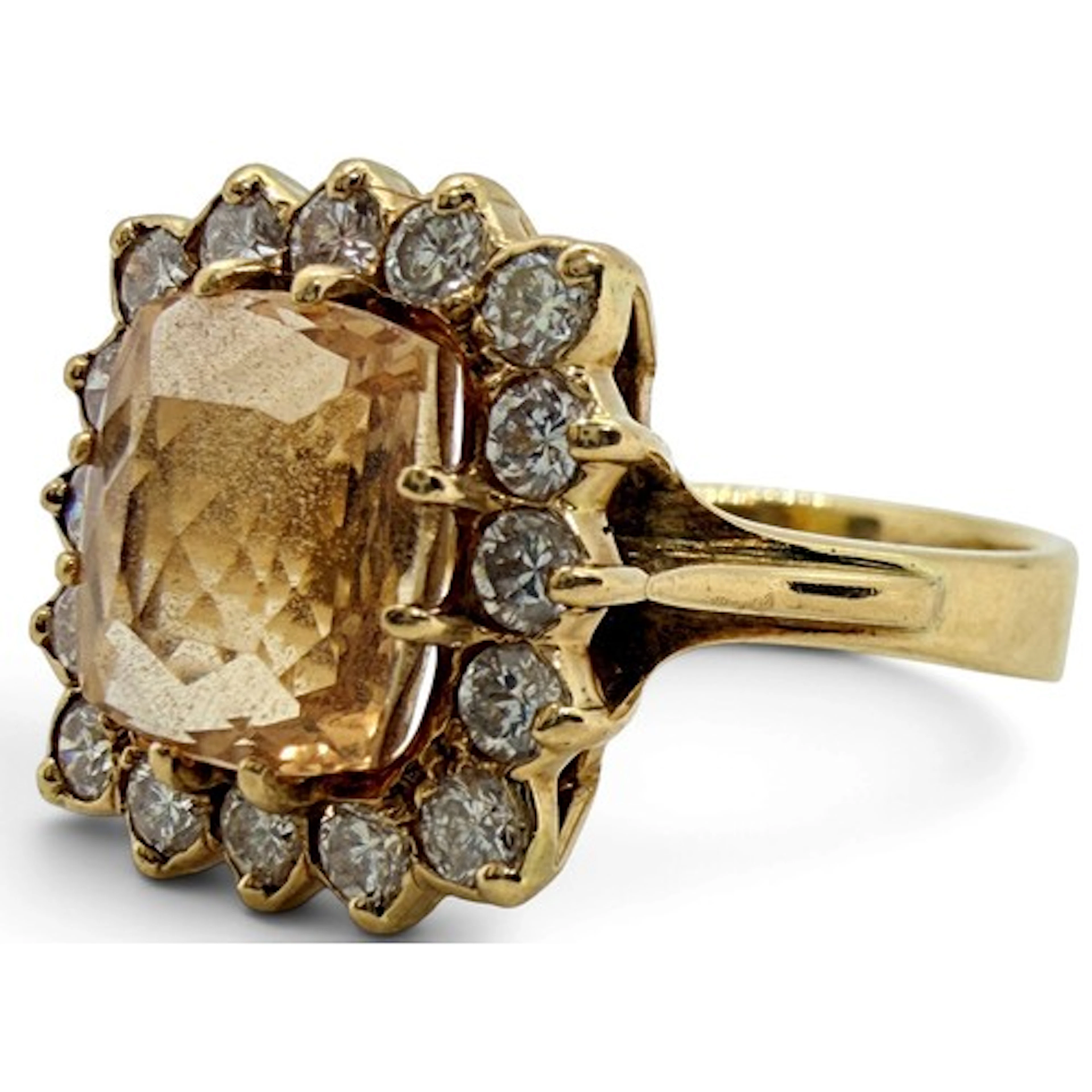 A gem-set dress ring, claw-set with a cushion-cut peach topa...