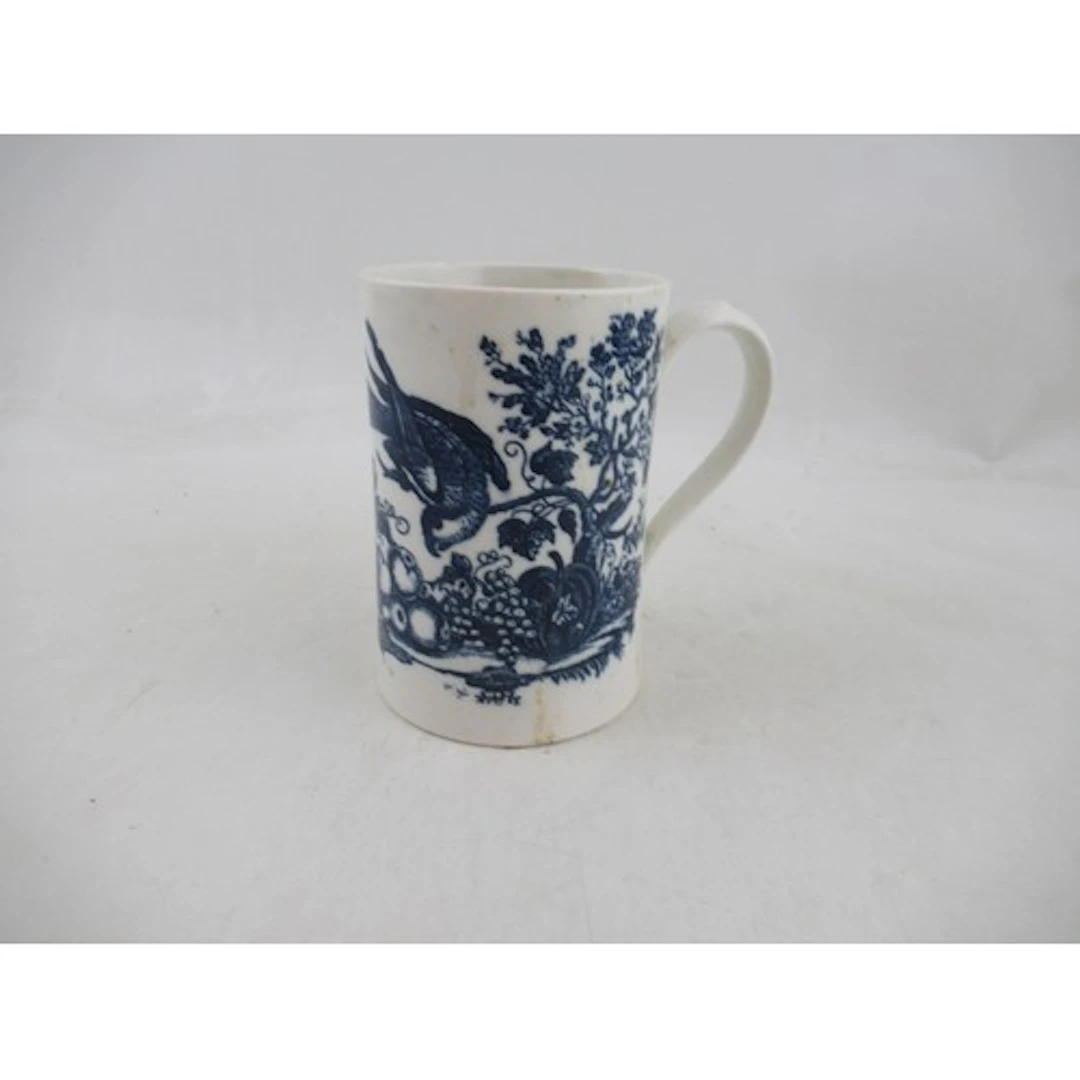 A 19th century English porcelain mug, decorated in blue and ...