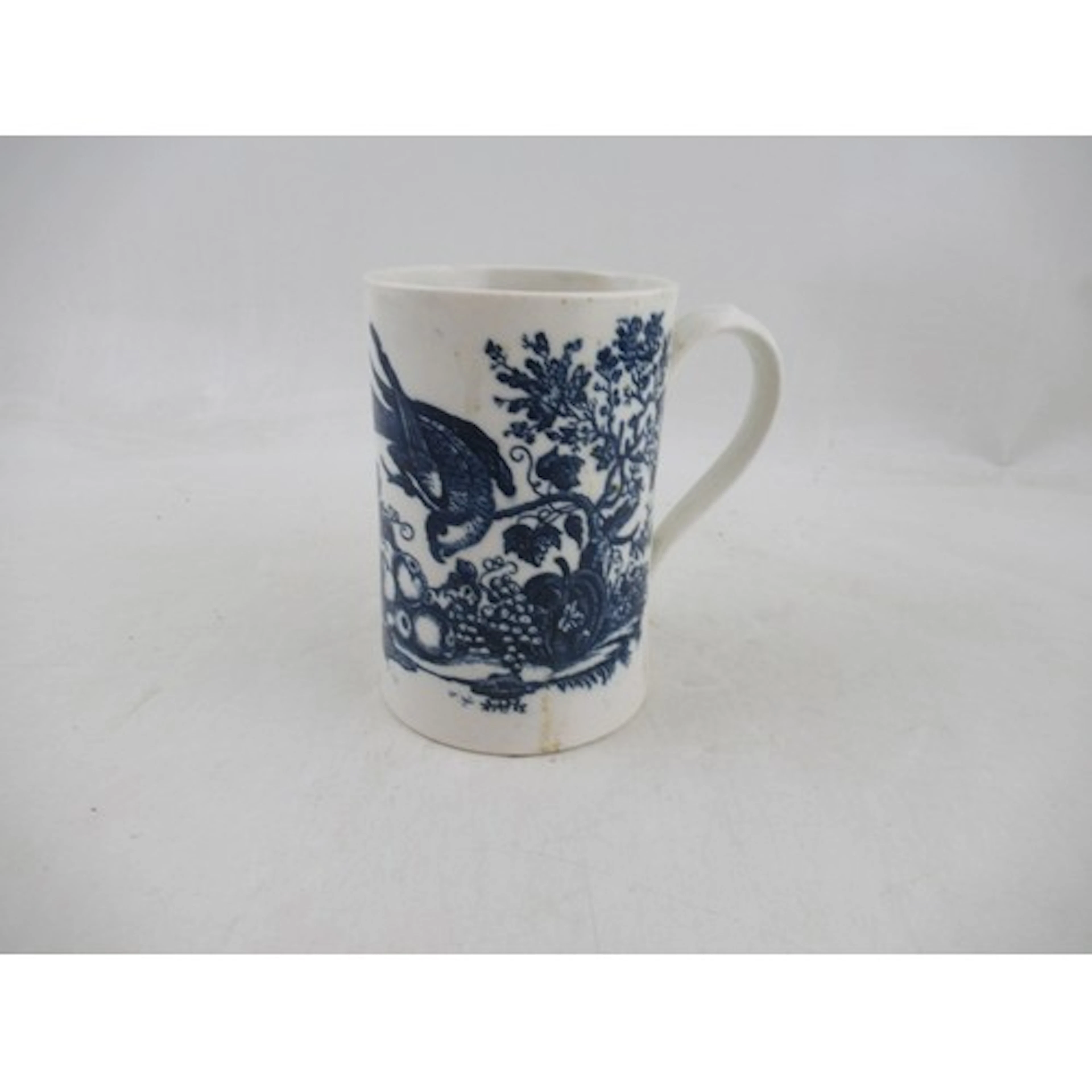 A 19th century English porcelain mug, decorated in blue and ...