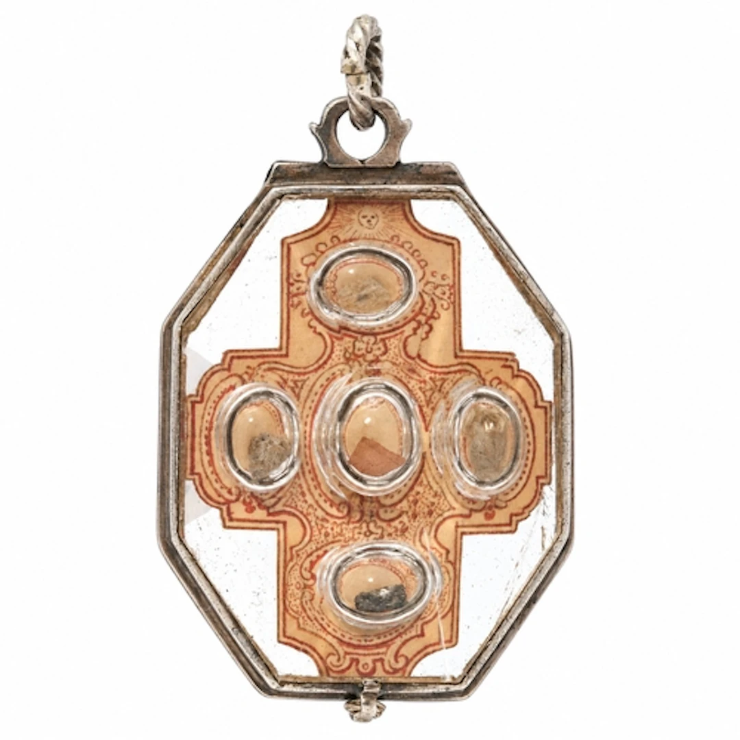 A rock-crystal reliquary pendant mounted in white metal with...