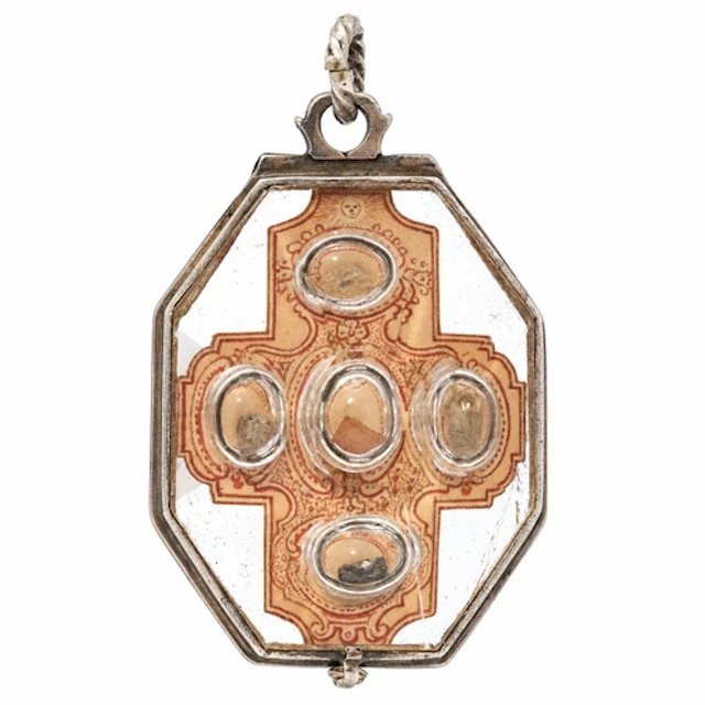 A rock-crystal reliquary pendant mounted in white metal with...