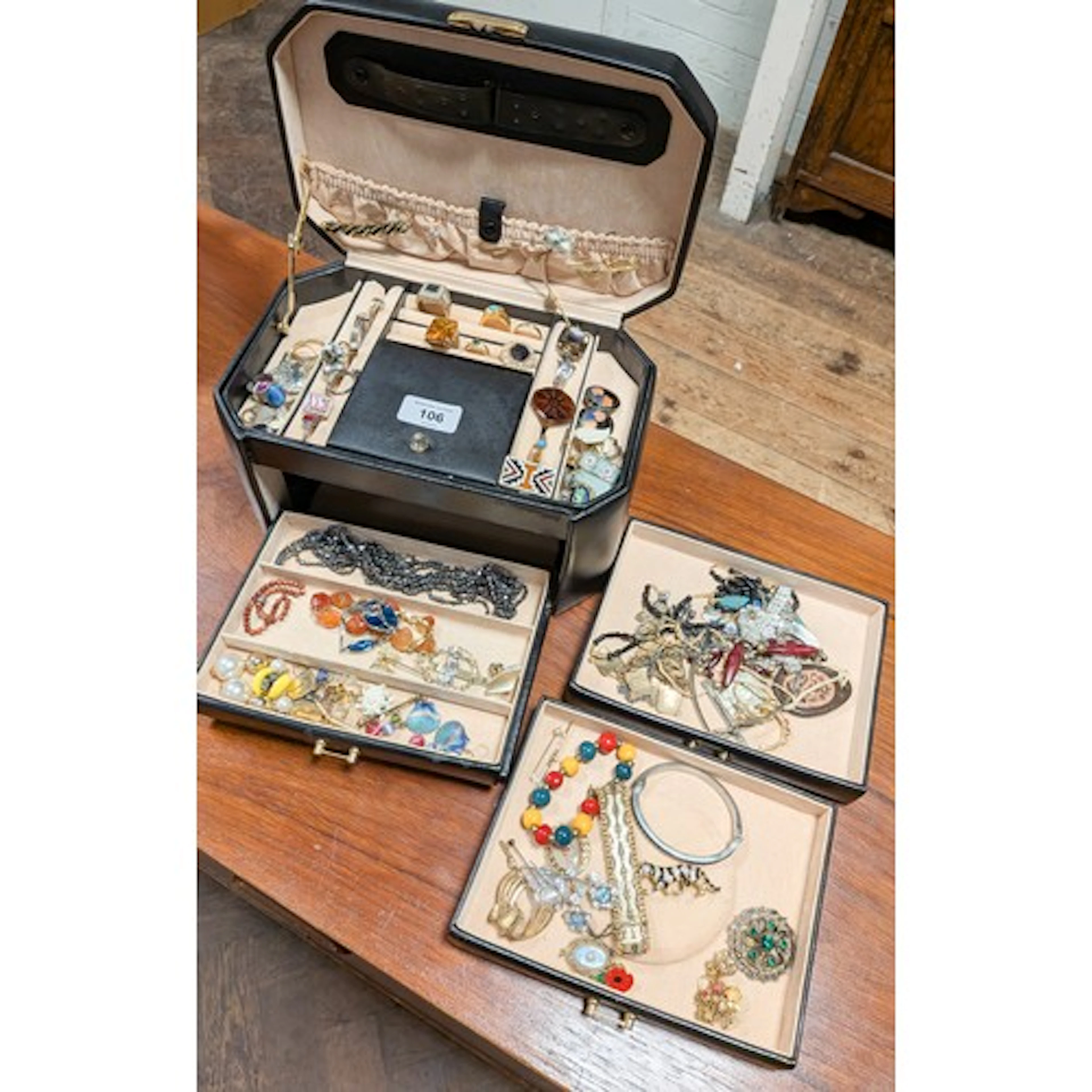 Ladies black jewellery box fitted three drawers and contents...