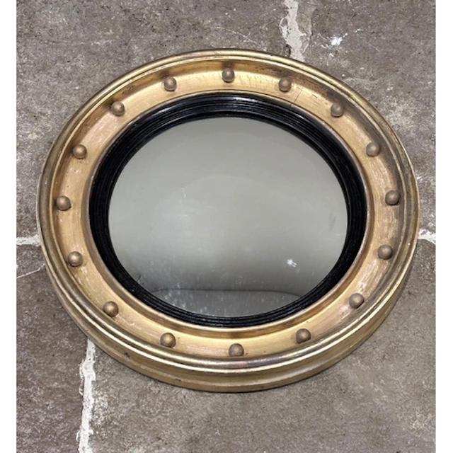 A Regency gilt convex mirror, the mirror plate within a blac...