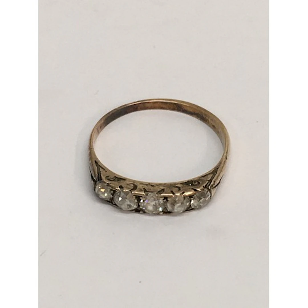 An unmarked gold ring set with old cut probable diamonds. Ap...