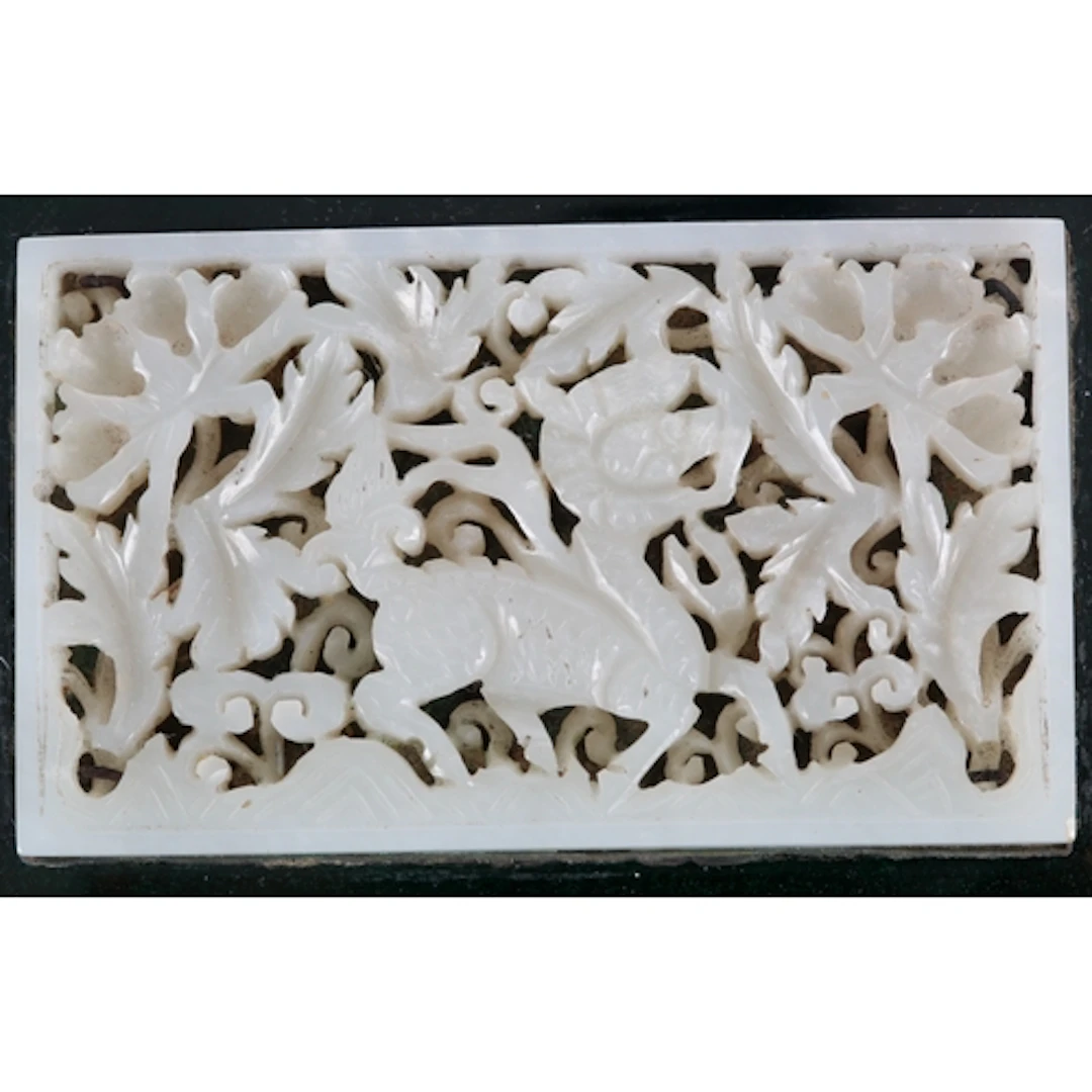 A Chinese pale celadon jade 'qilin' plaque, 17th century, mo...