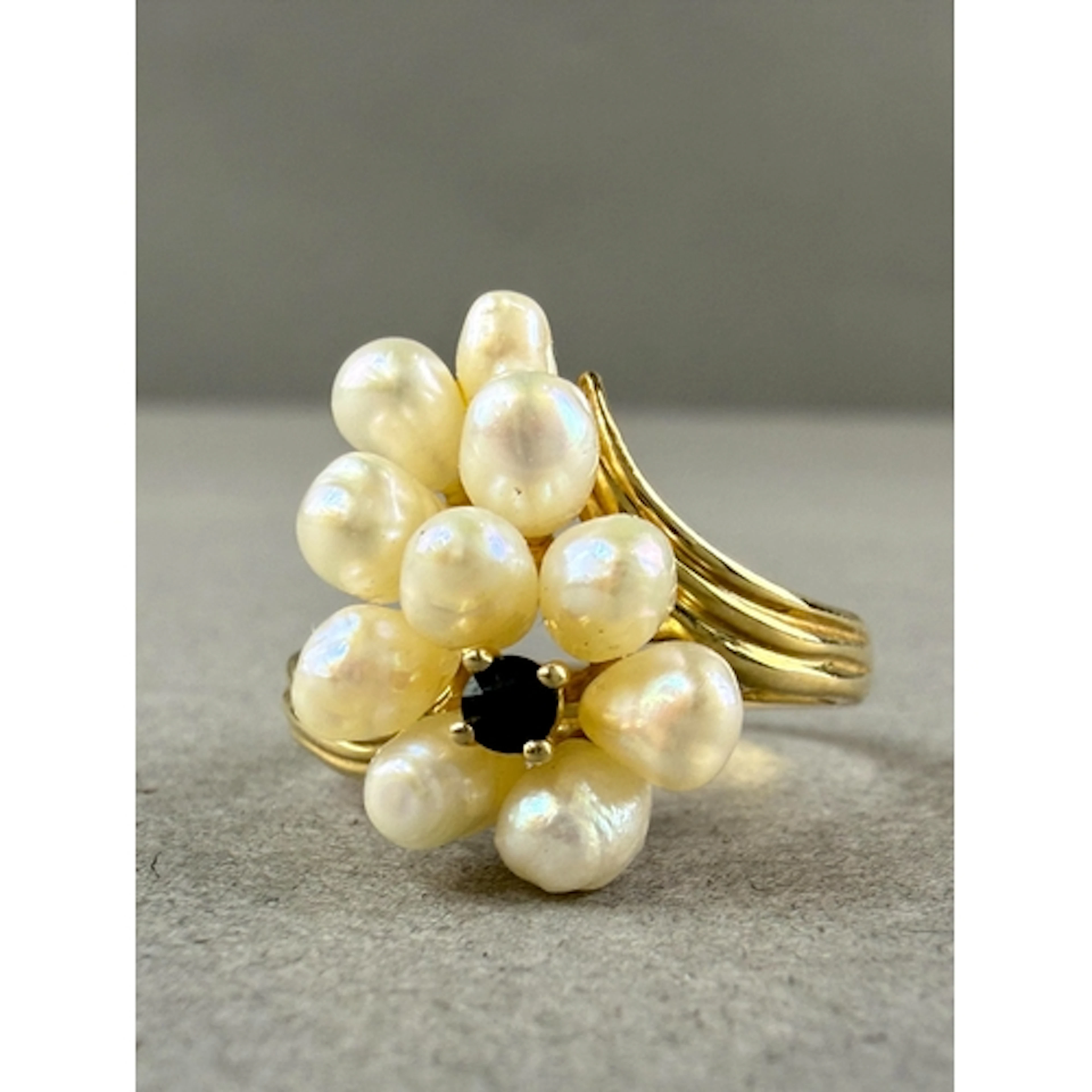 Jewellery: a yellow metal, sapphire and freshwater pearl clu...