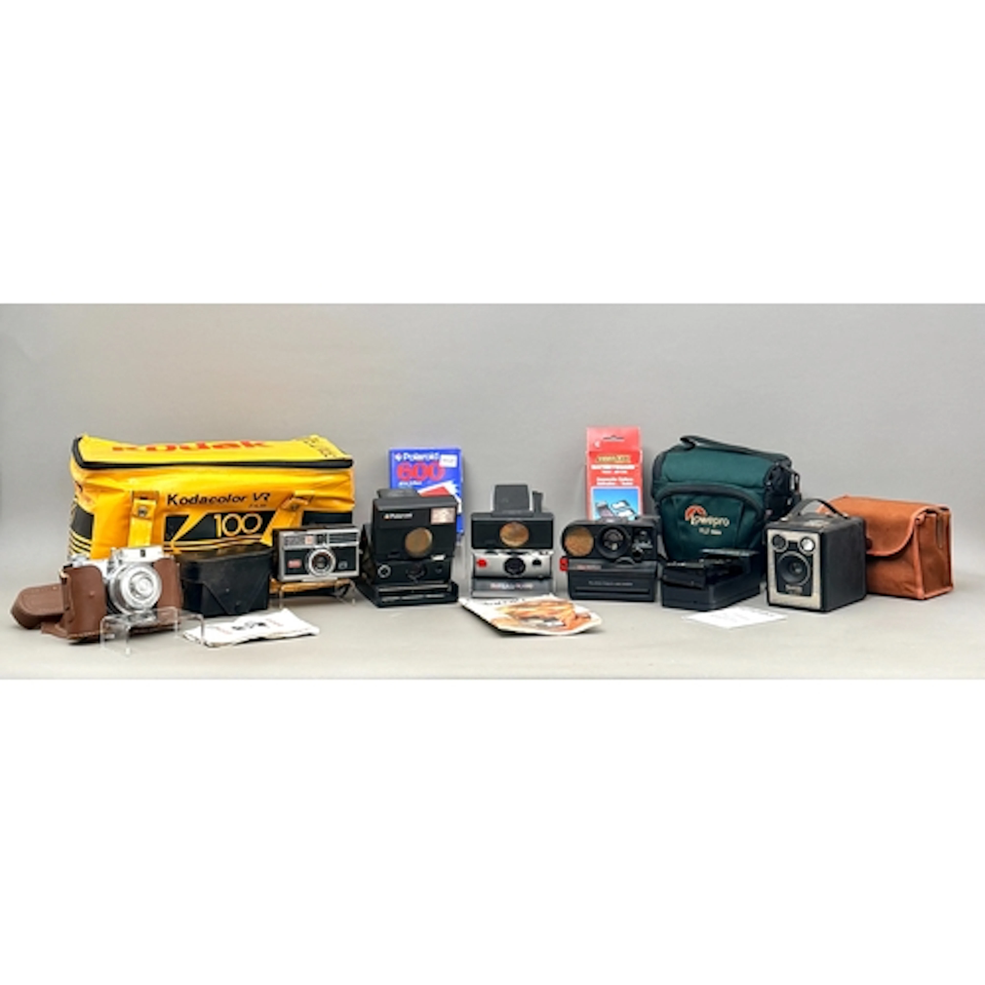 A collection of vintage cameras - a Polaroid Pronto Land Cam...