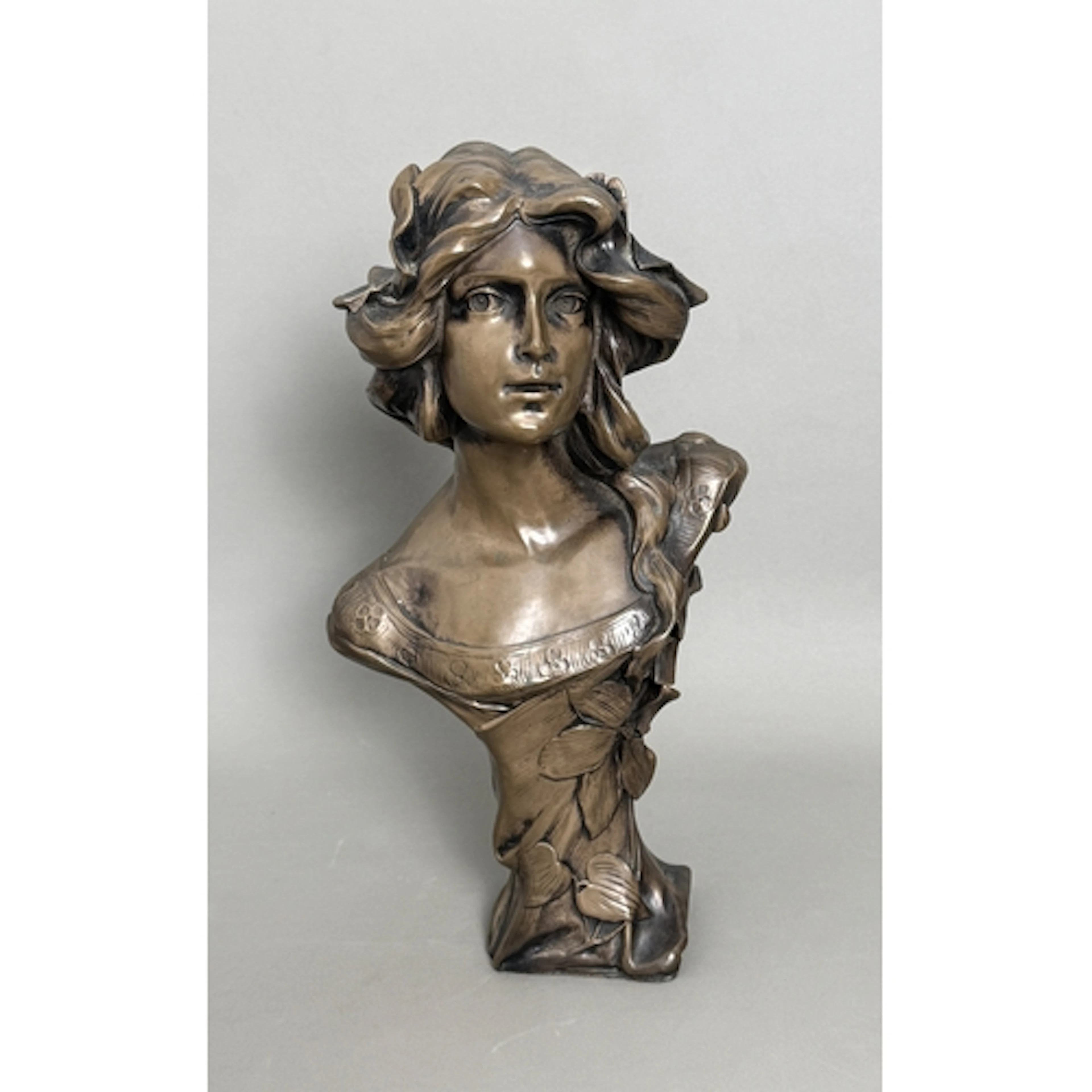 An Art Nouveau style bronzed resin bust of a lady - with flo...