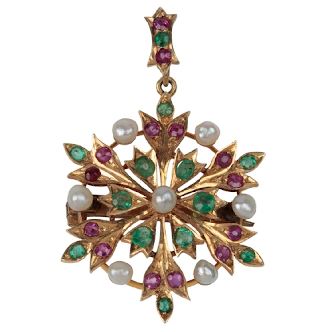 An unmarked yellow metal, emerald, ruby and pearl cluster se...
