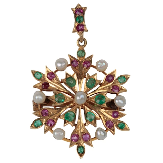 An unmarked yellow metal, emerald, ruby and pearl cluster se...