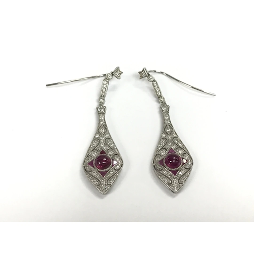 Pair of platinum art deco style drop earrings set with a cen...