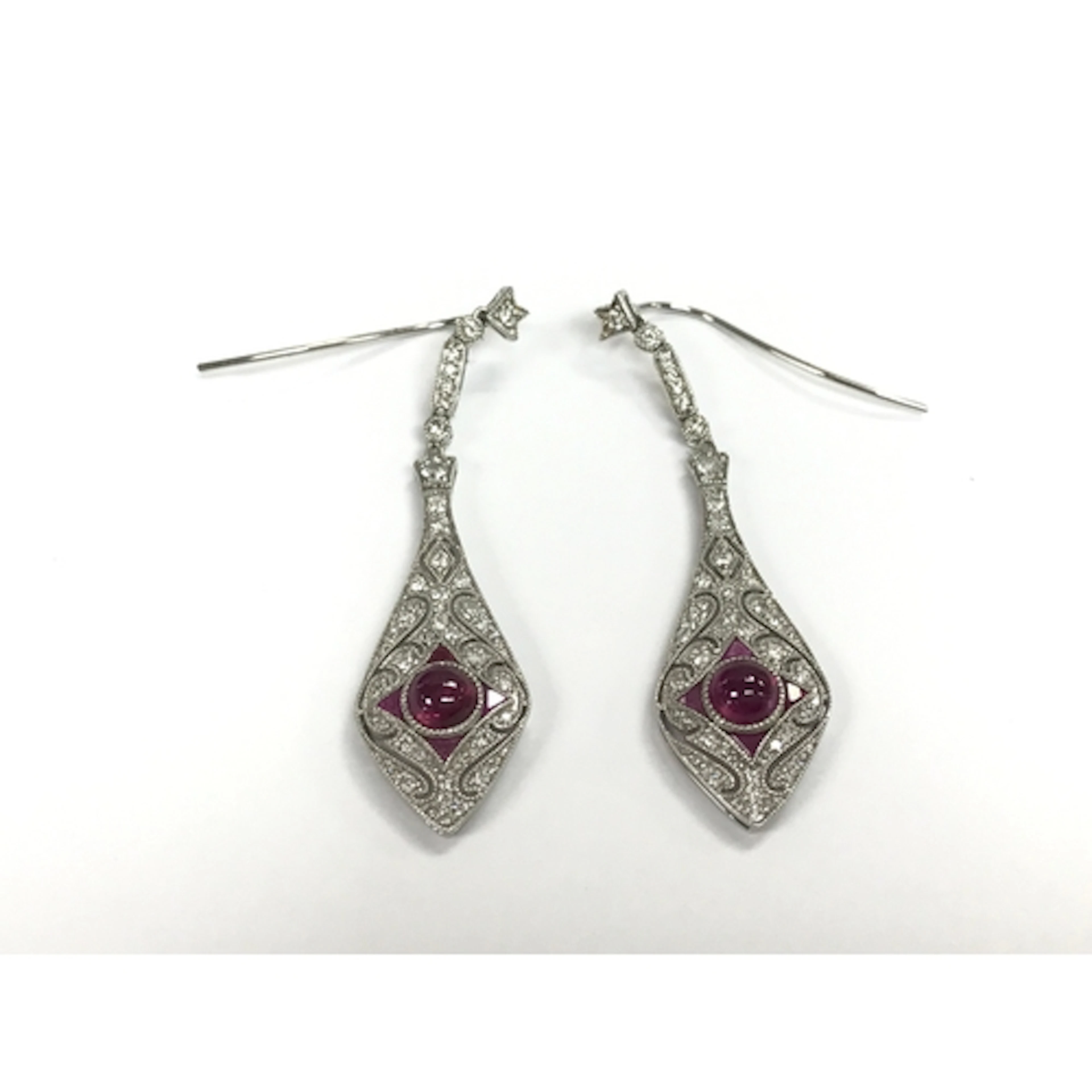 Pair of platinum art deco style drop earrings set with a cen...