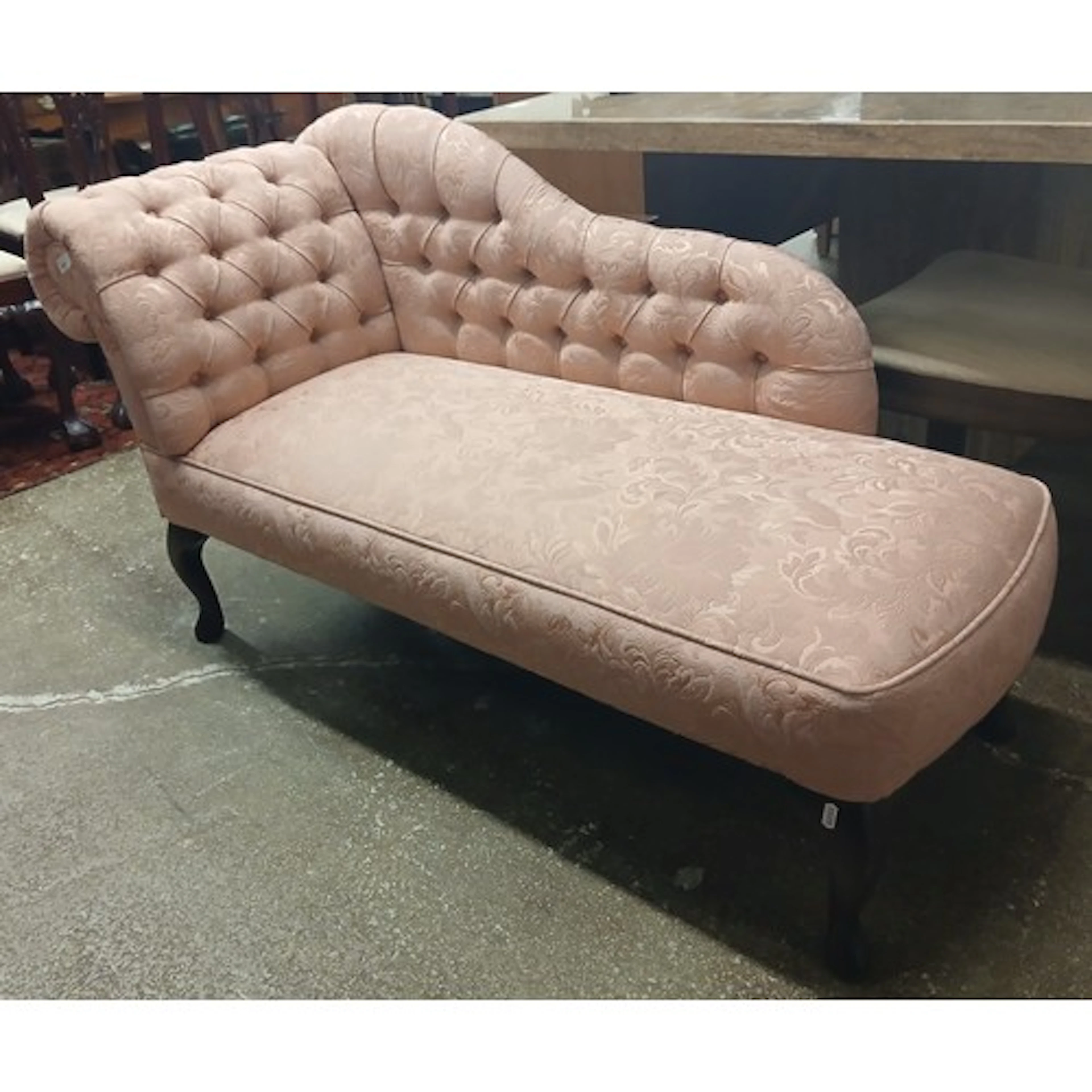 Pink upholstered chaise lounge.