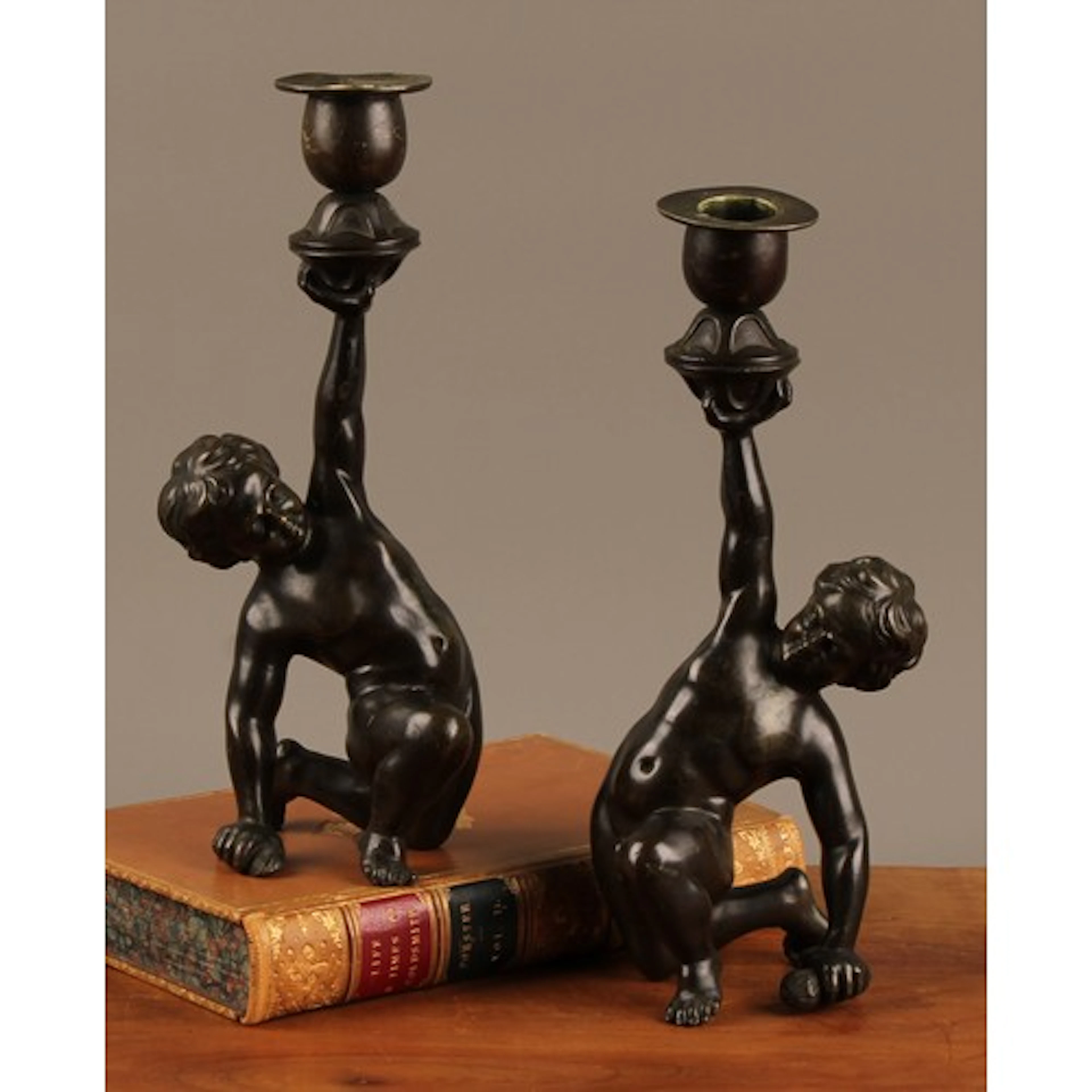 A pair of 19th century brown patinated bronze figural candle...