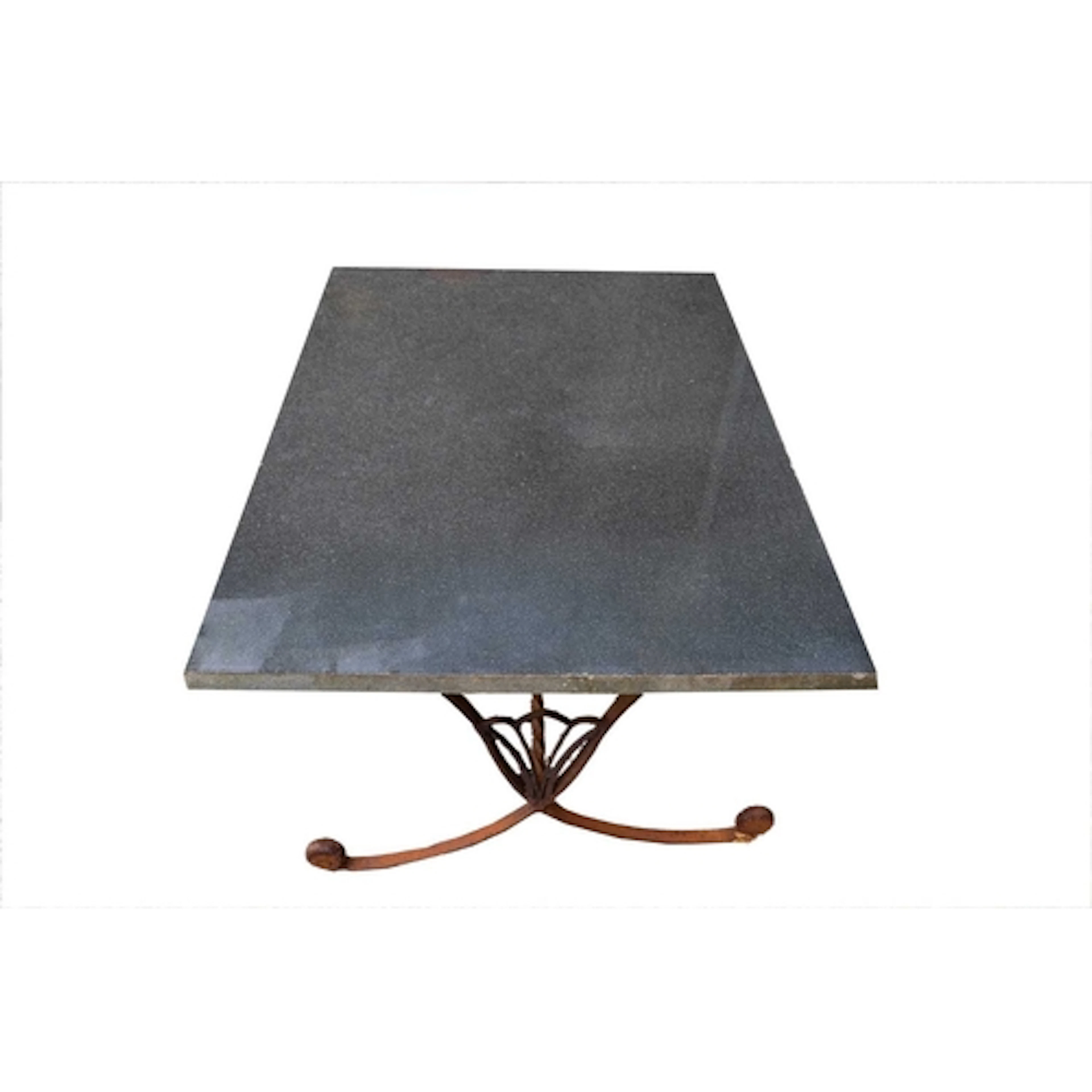 A low garden or conservatory table. The wrought metal base w...