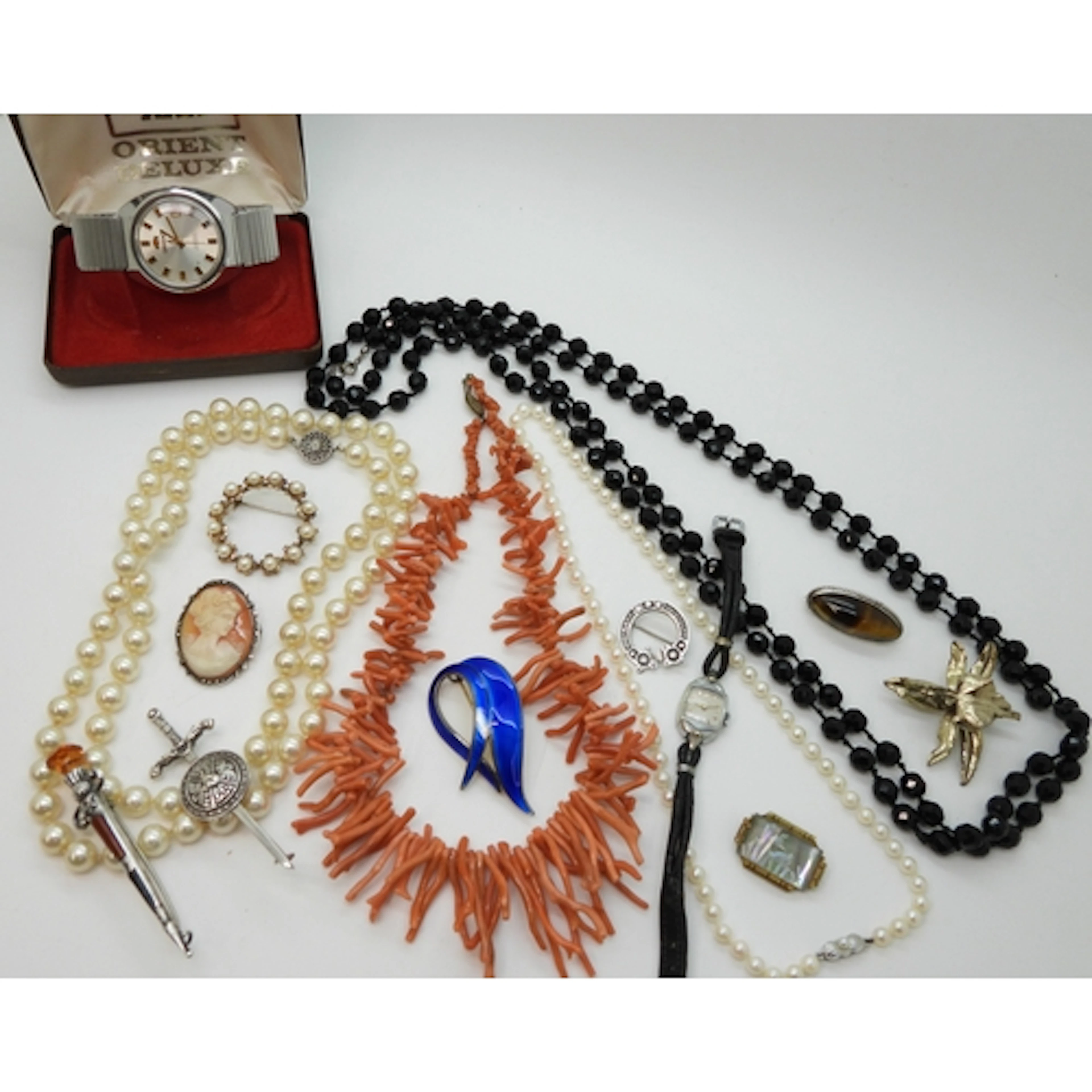 A string of coral fringe beads, a Norwegian blue enamel broo...