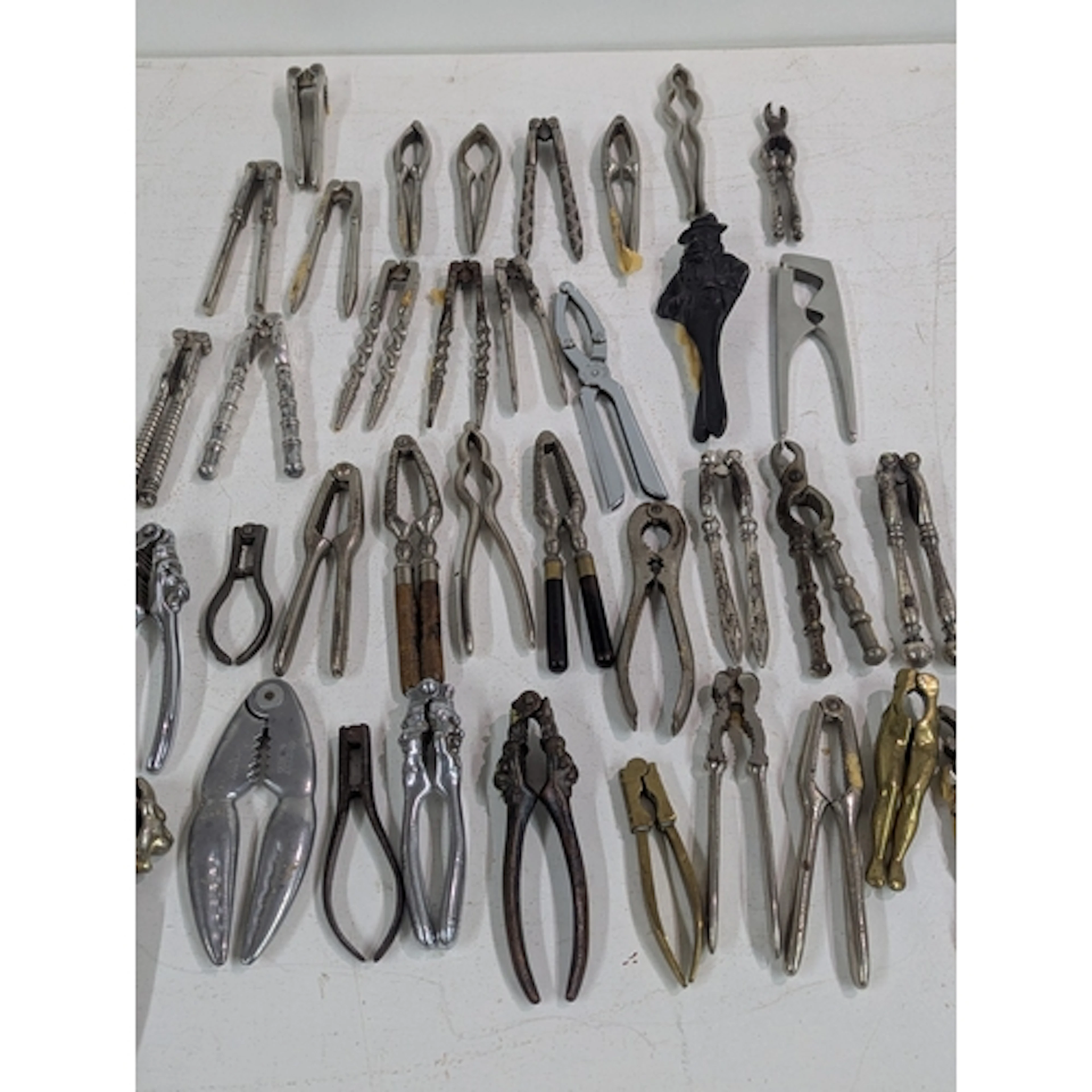A collection of vintage nut crackers, one pair fashioned as ...