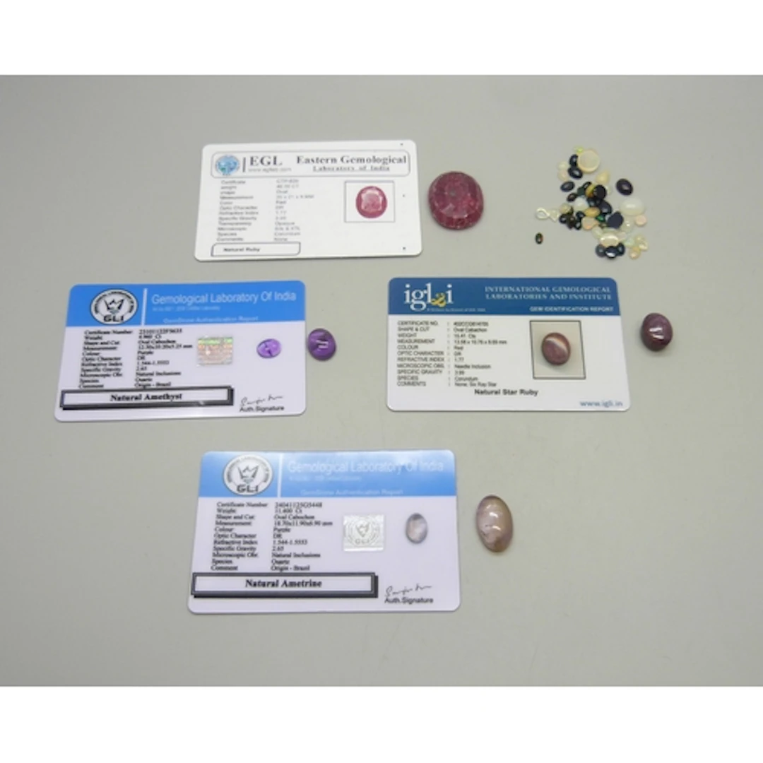 A collection of loose opals and other gemstones, together wi...
