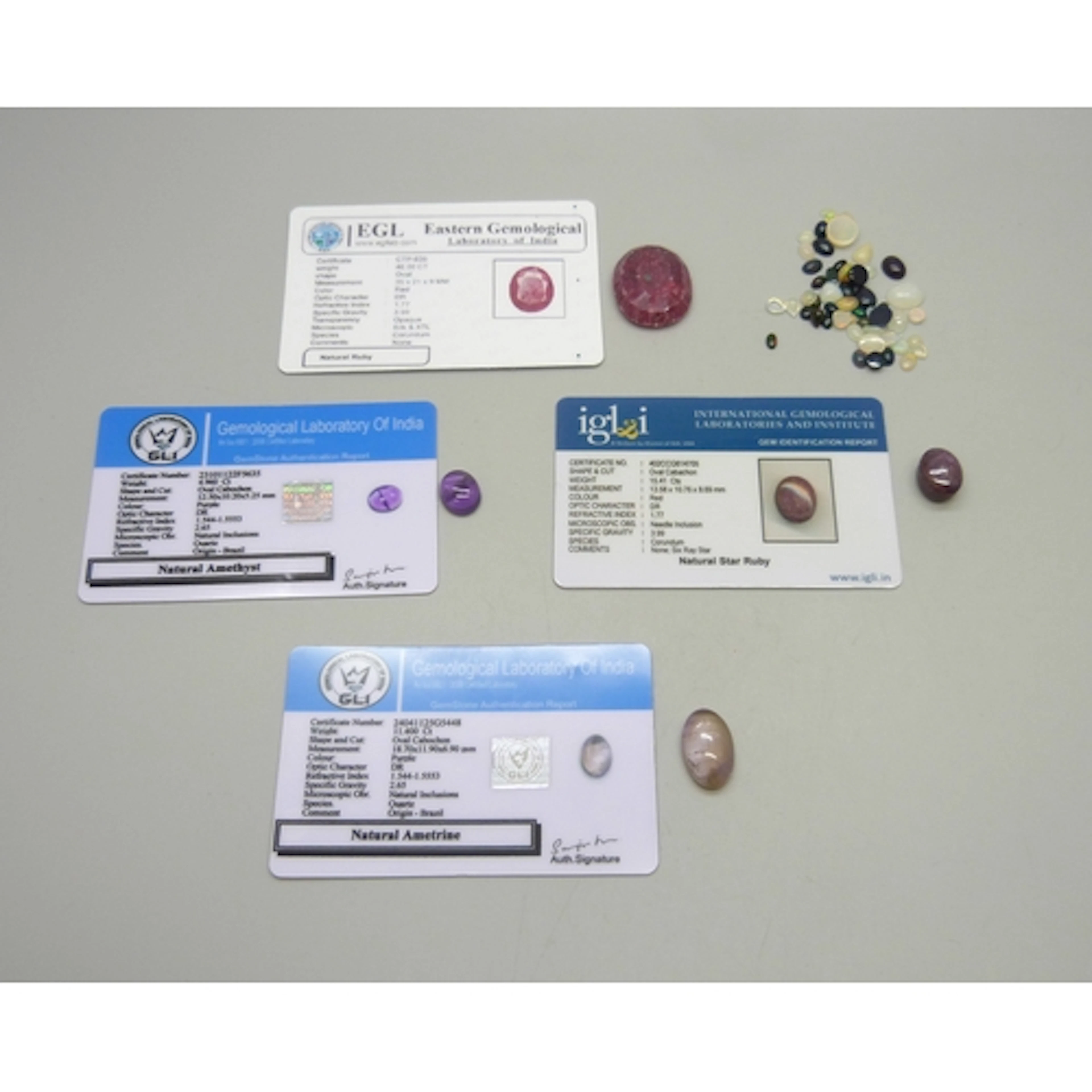 A collection of loose opals and other gemstones, together wi...