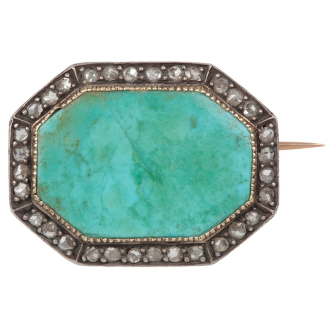 A turquoise and diamond brooch, early 20th century, set with...