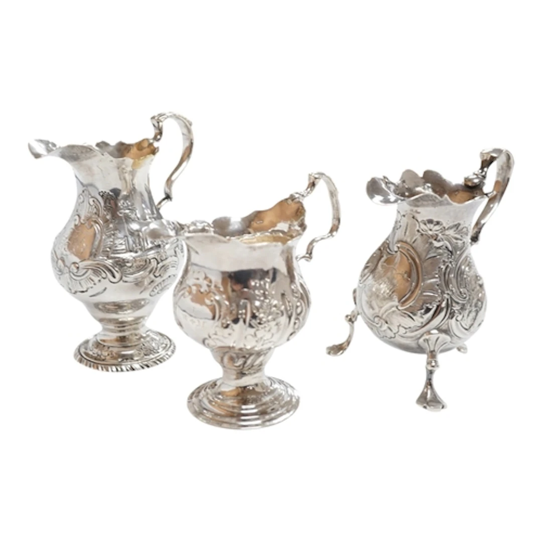 Three assorted George III silver cream jugs, all with later ...