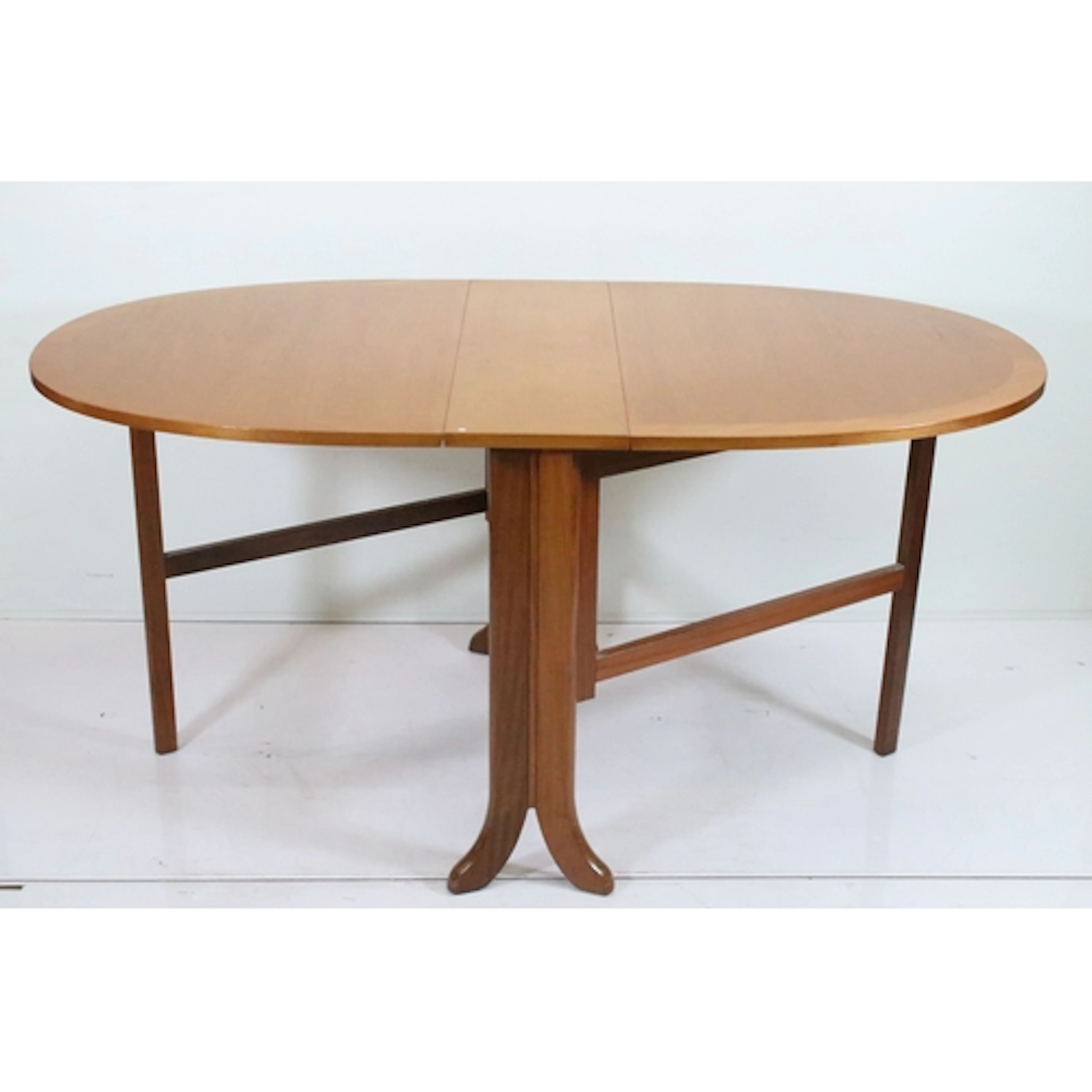 Mid 20th century teak drop-leaf table, having oval top with ...