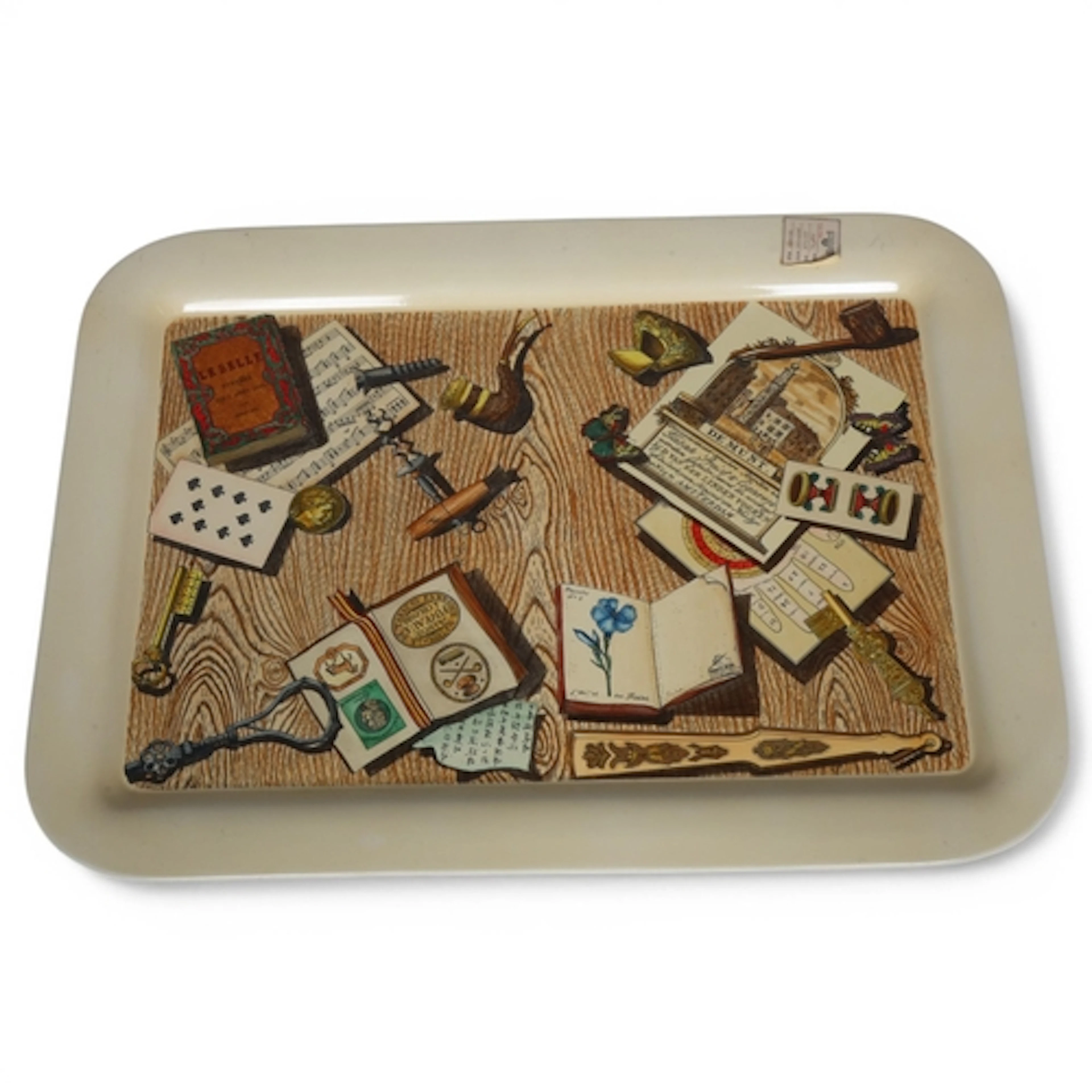 A large Fornasetti Trompe L'oeil tray, screen printed lacque...