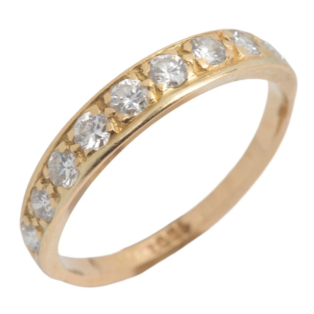 A gold and diamond half hoop ring, claw-set with a line of c...