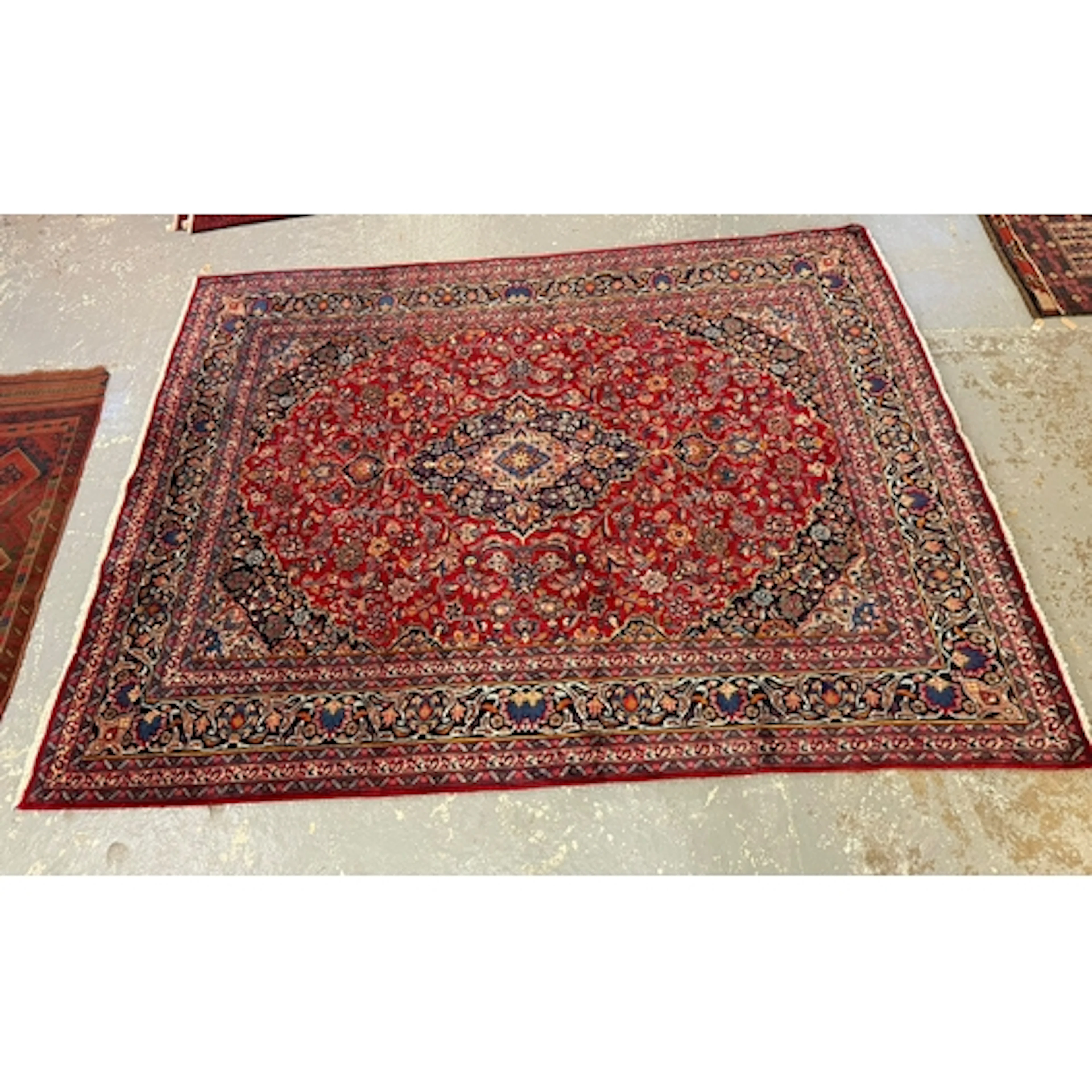 Iranian large red ground carpet with floral medallion design...