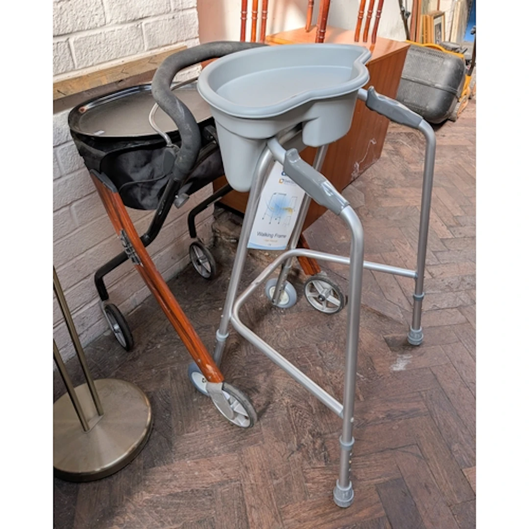 A mobility aid with attached tray and one other aid